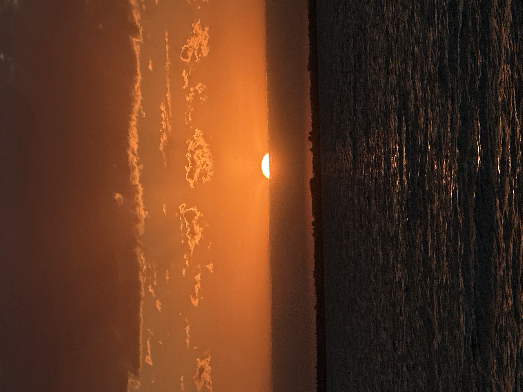 Warm sunset light spreads across a Kazakh lakeshore