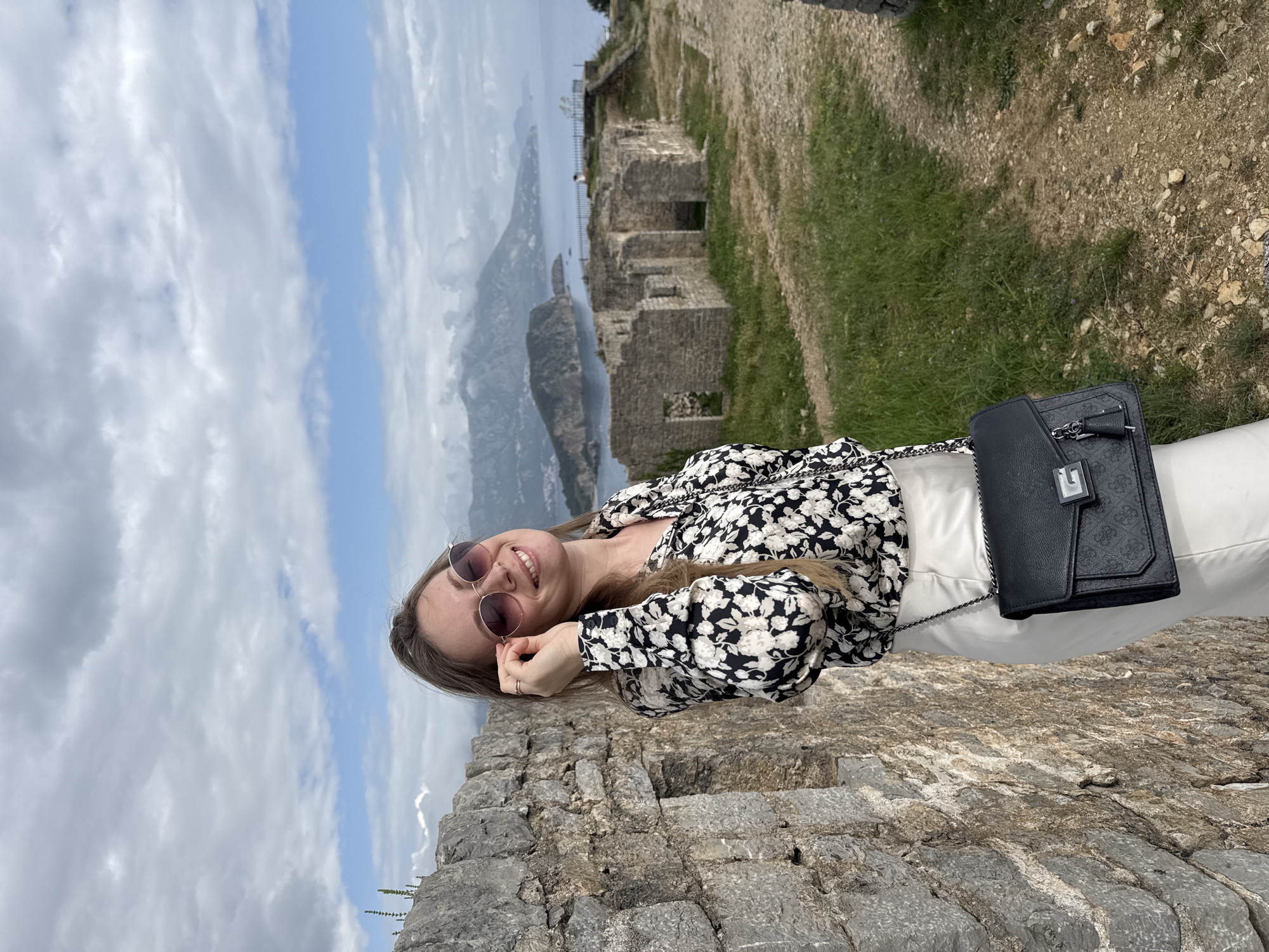 Tourists visit Budva's Old Fortress on cloudy afternoon