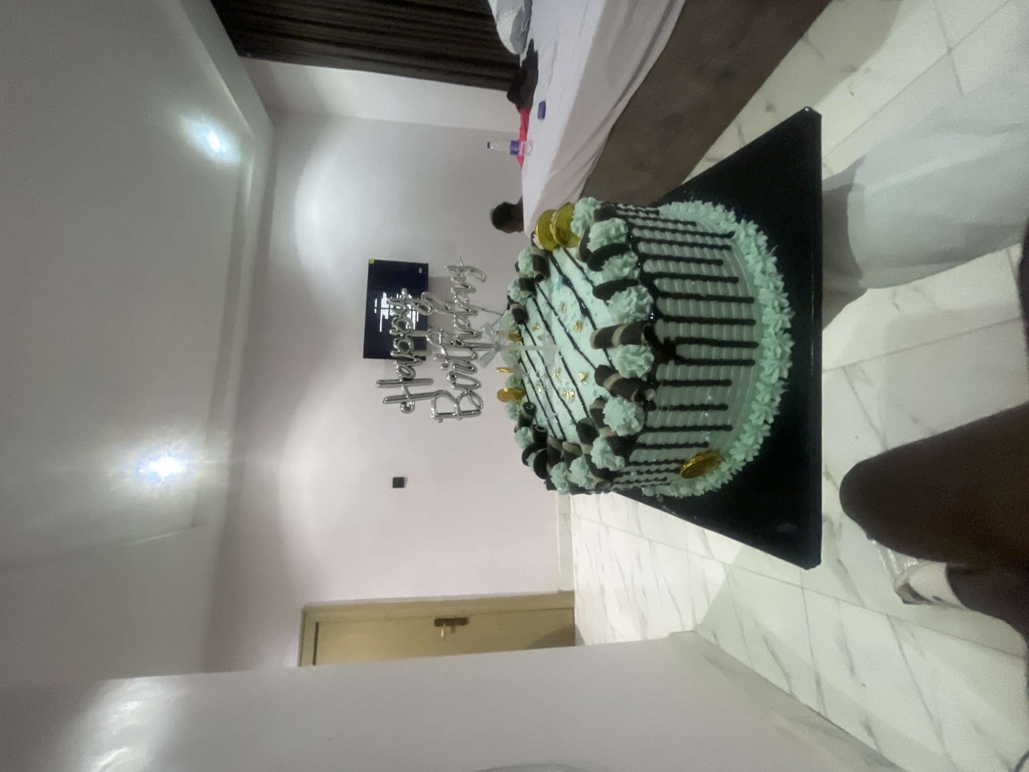 Birthday morning in an Abuja hotel room, cake and all