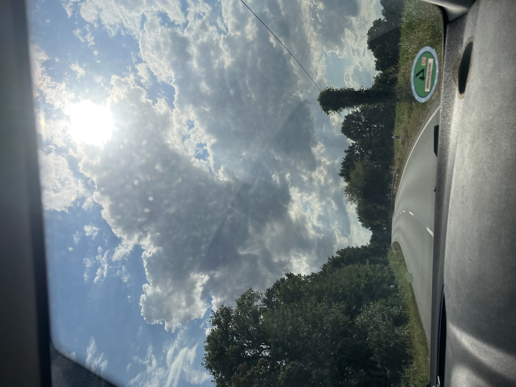 Afternoon highway drive through rural countryside with wind turbines