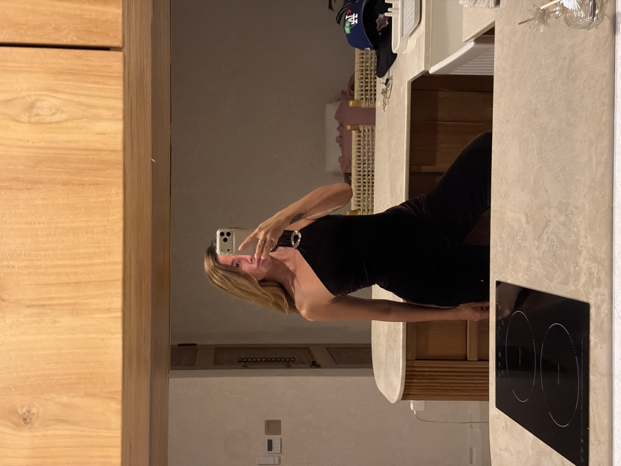 Mirror selfies in a modern Mengwi bathroom, black dress and LED light.