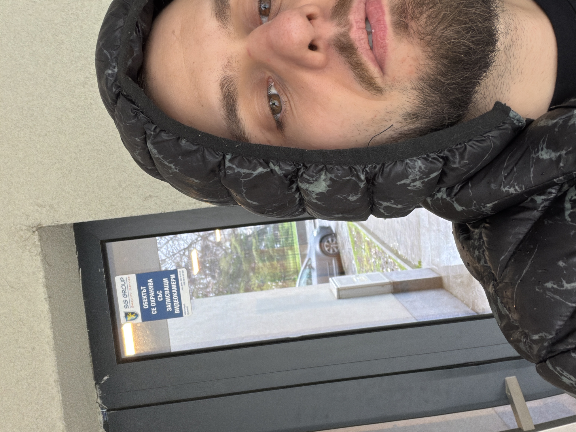 Man takes selfie near business window in Plovdiv