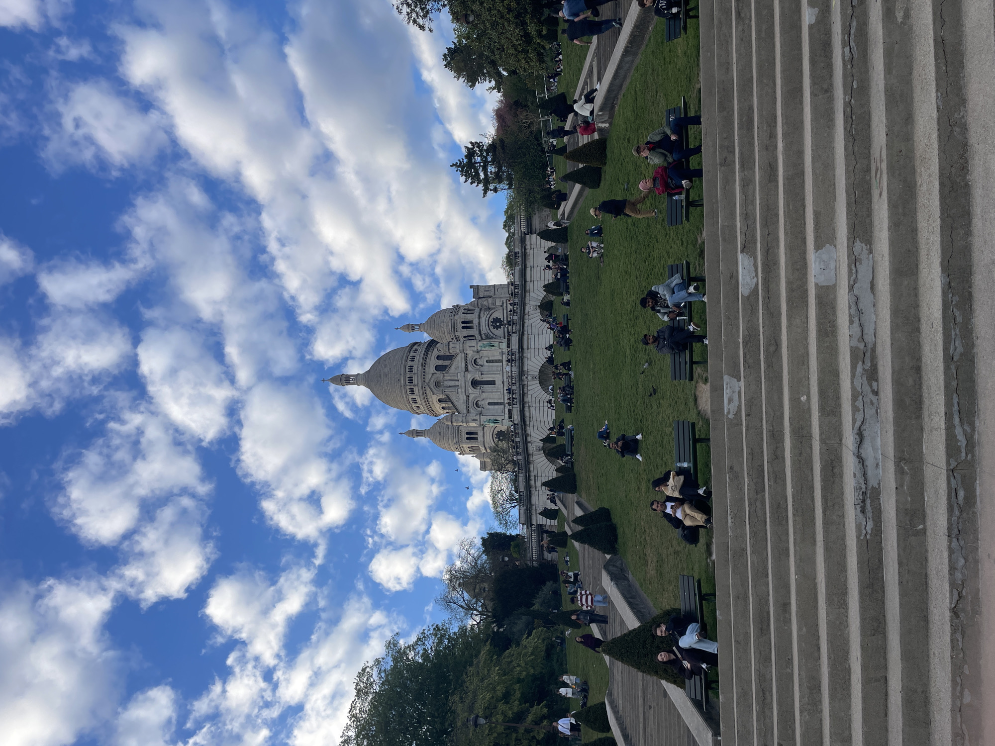 Tourist captures Sacré-Cœur and Paris panorama from Montmartre