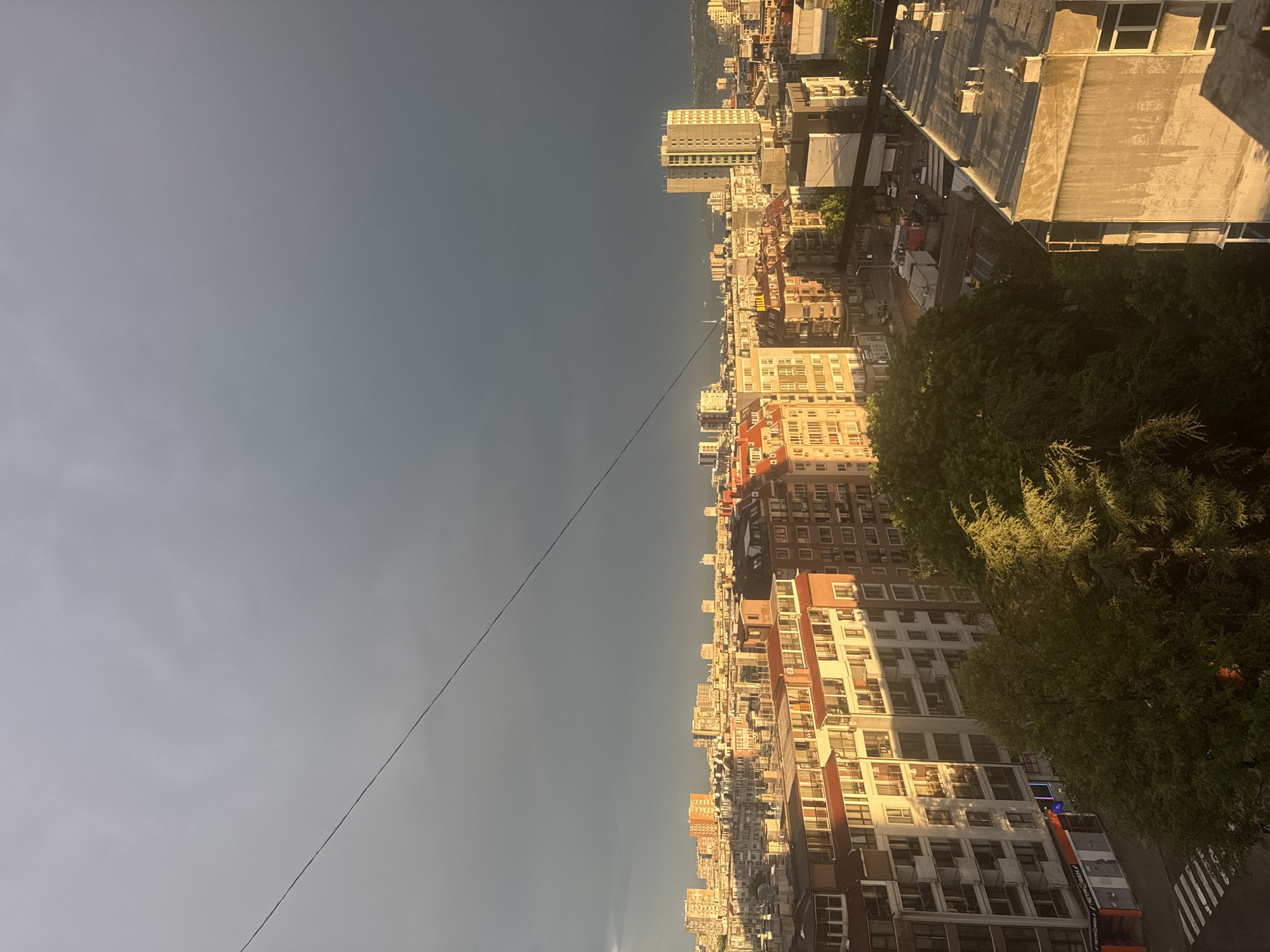 Elevated cityscape view with power lines captured from rooftop