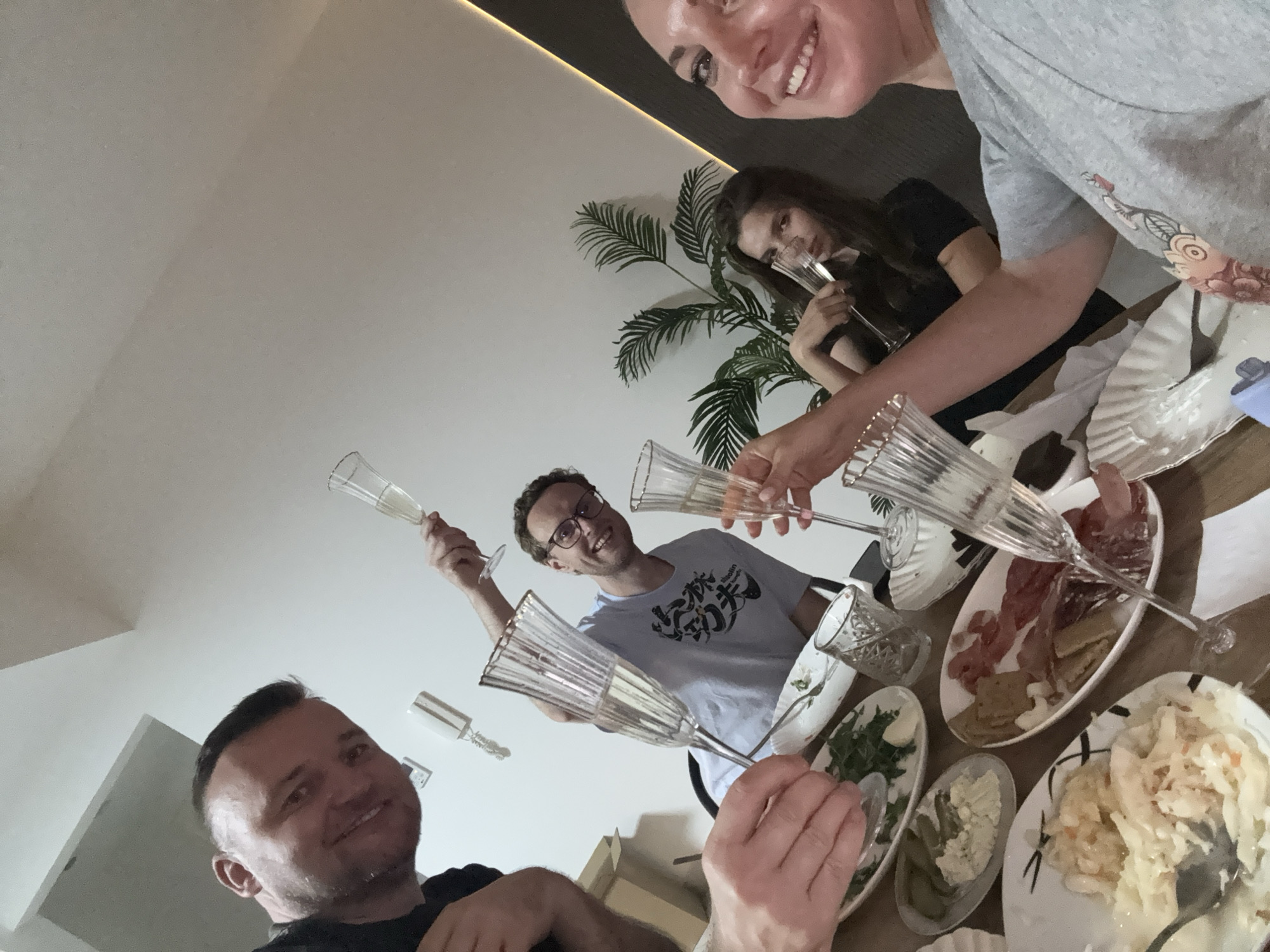 Group celebrates with champagne and charcuterie spread in Dubai