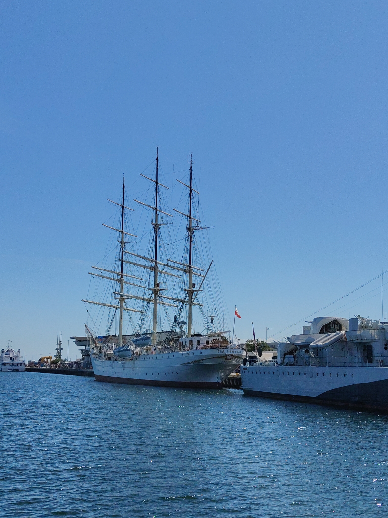 ORP Iskra and tall ships at Gdynia's sunny harbor