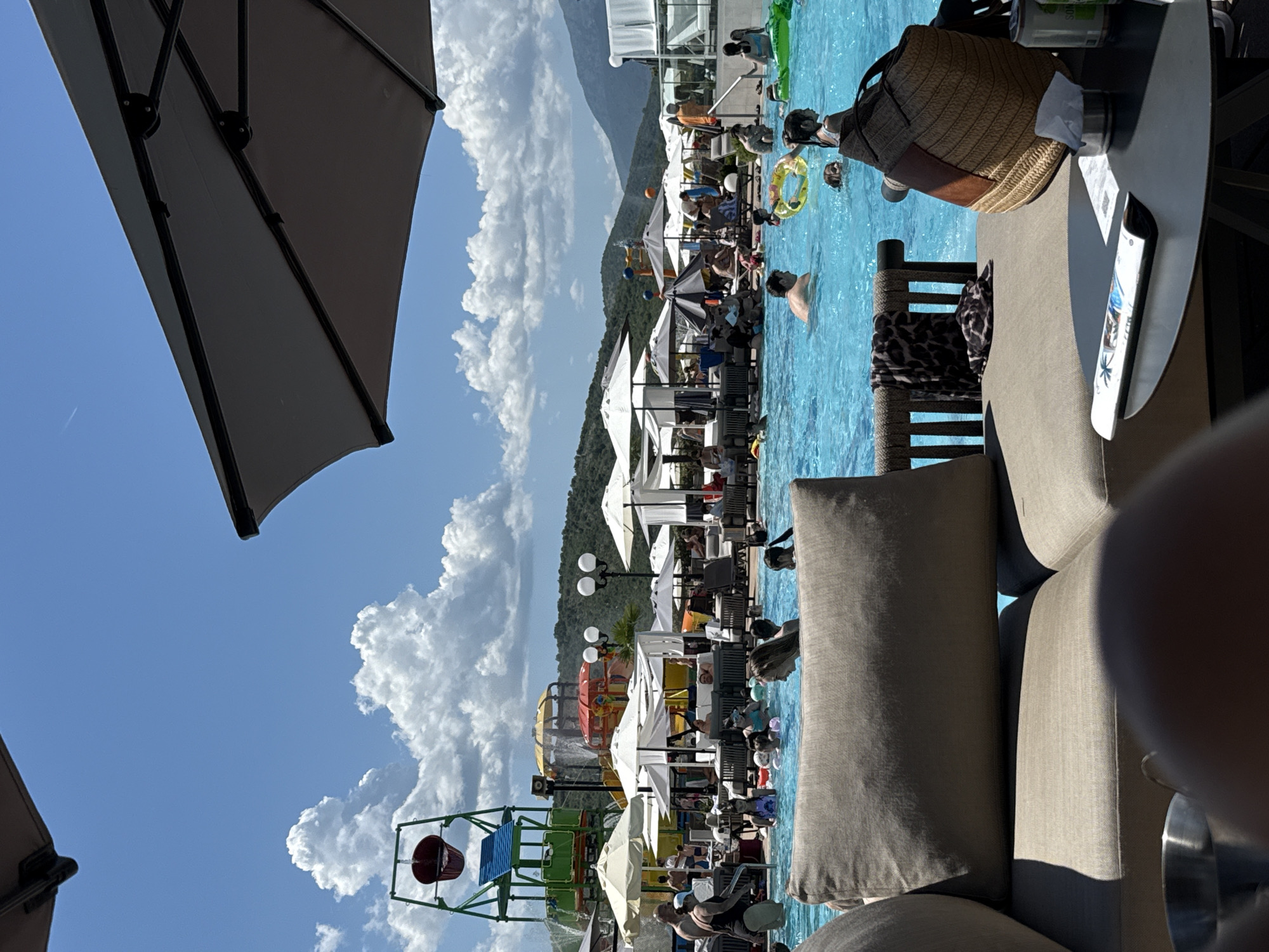 Poolside lunch gathering with pizza and drinks captured