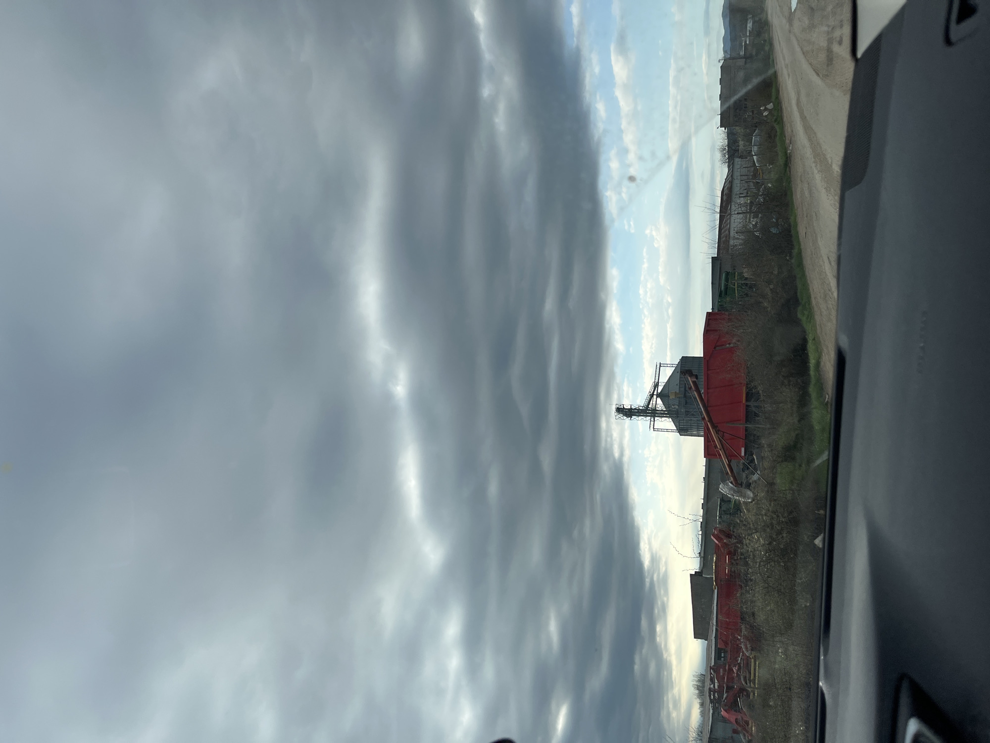 Vehicle passenger observes cloudy rural landscape near Vratsa, Bulgaria