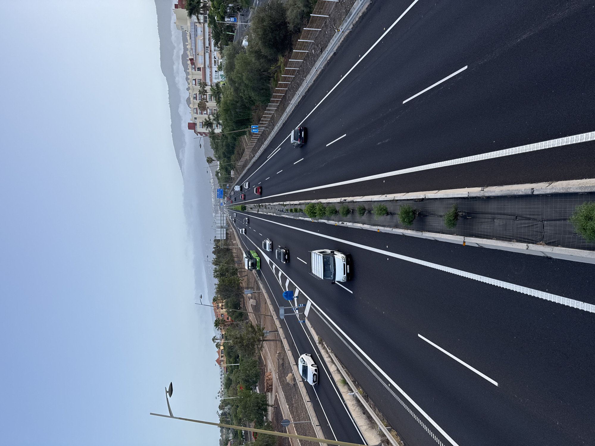 Hazy morning highway and mountain silhouettes in Adeje