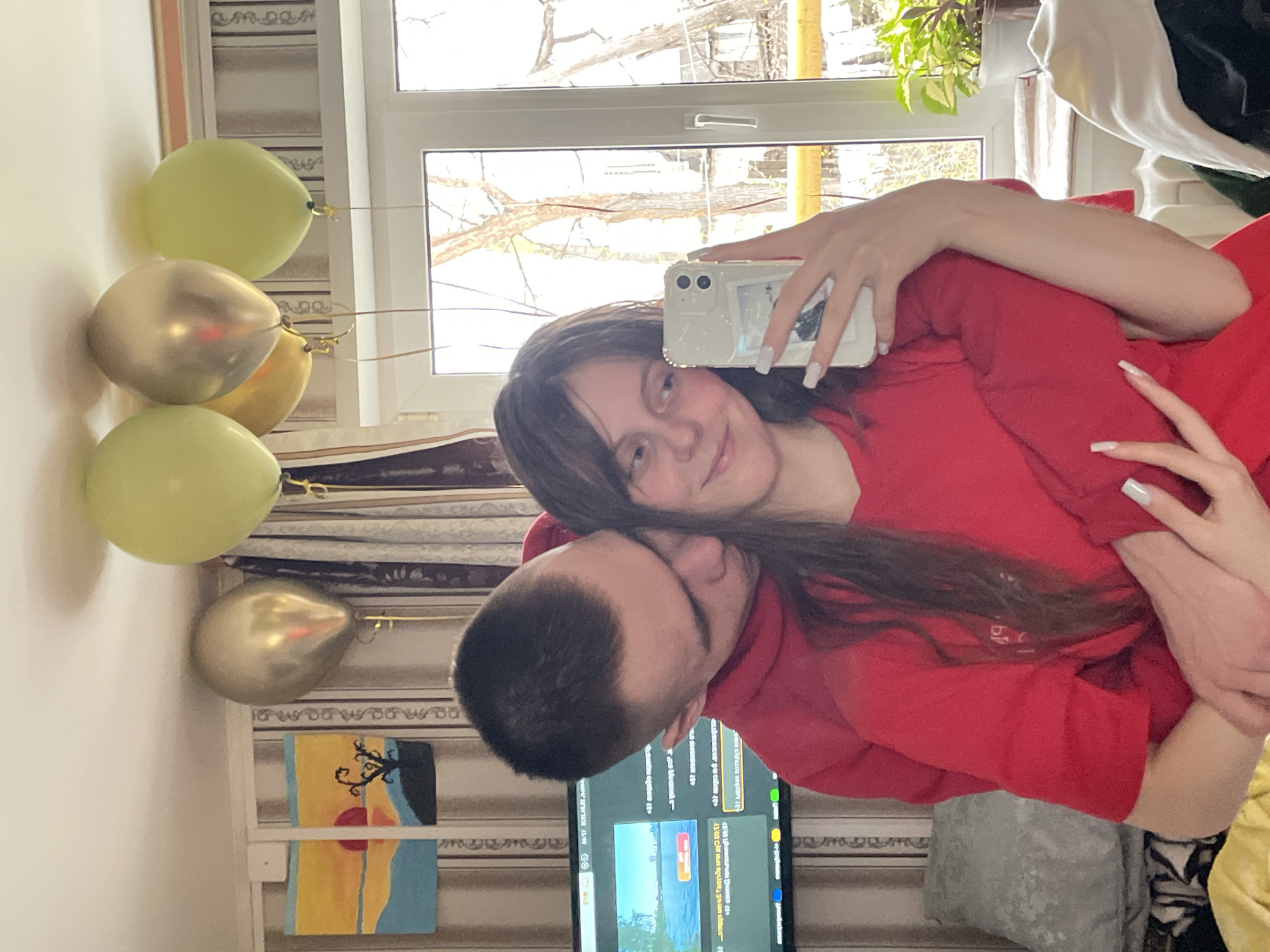 Couple documents indoor celebration with selfies and balloons in Russia