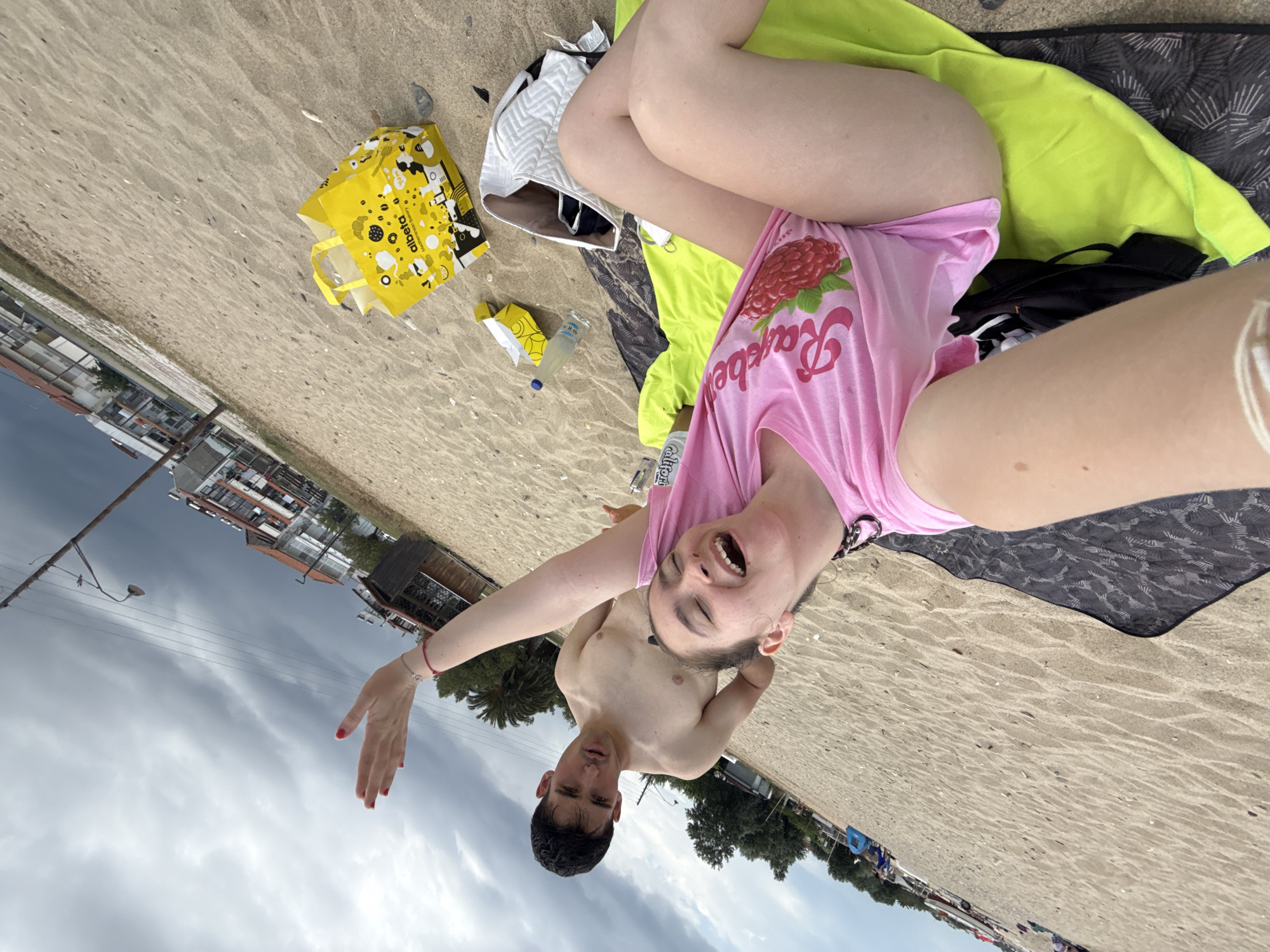 Beachgoers pose for selfies at Greek seaside resort