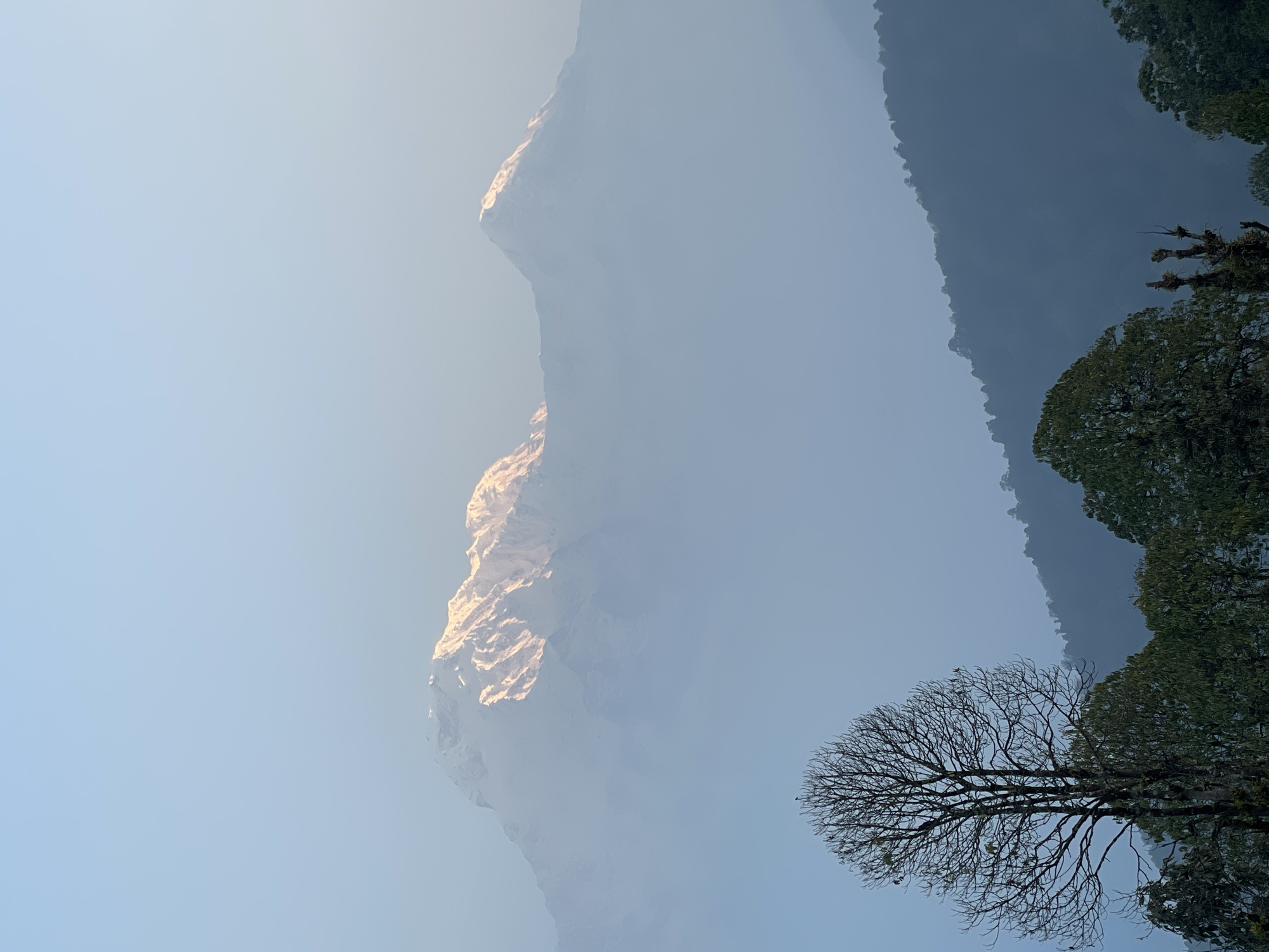 Mountain landscape documented in hazy conditions at Dhampus, Nepal