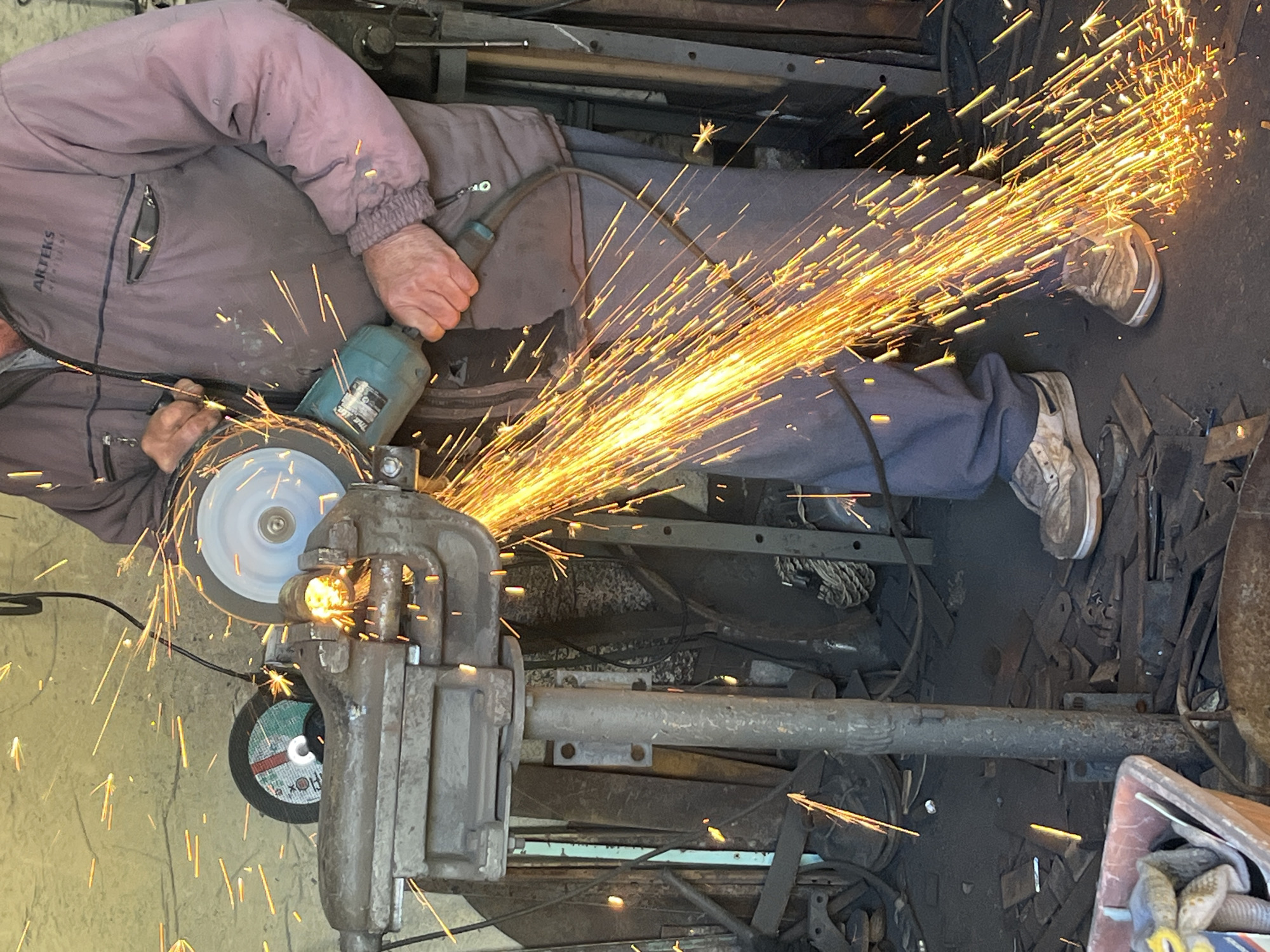 Metalworker performs grinding, welding operations in workshop session