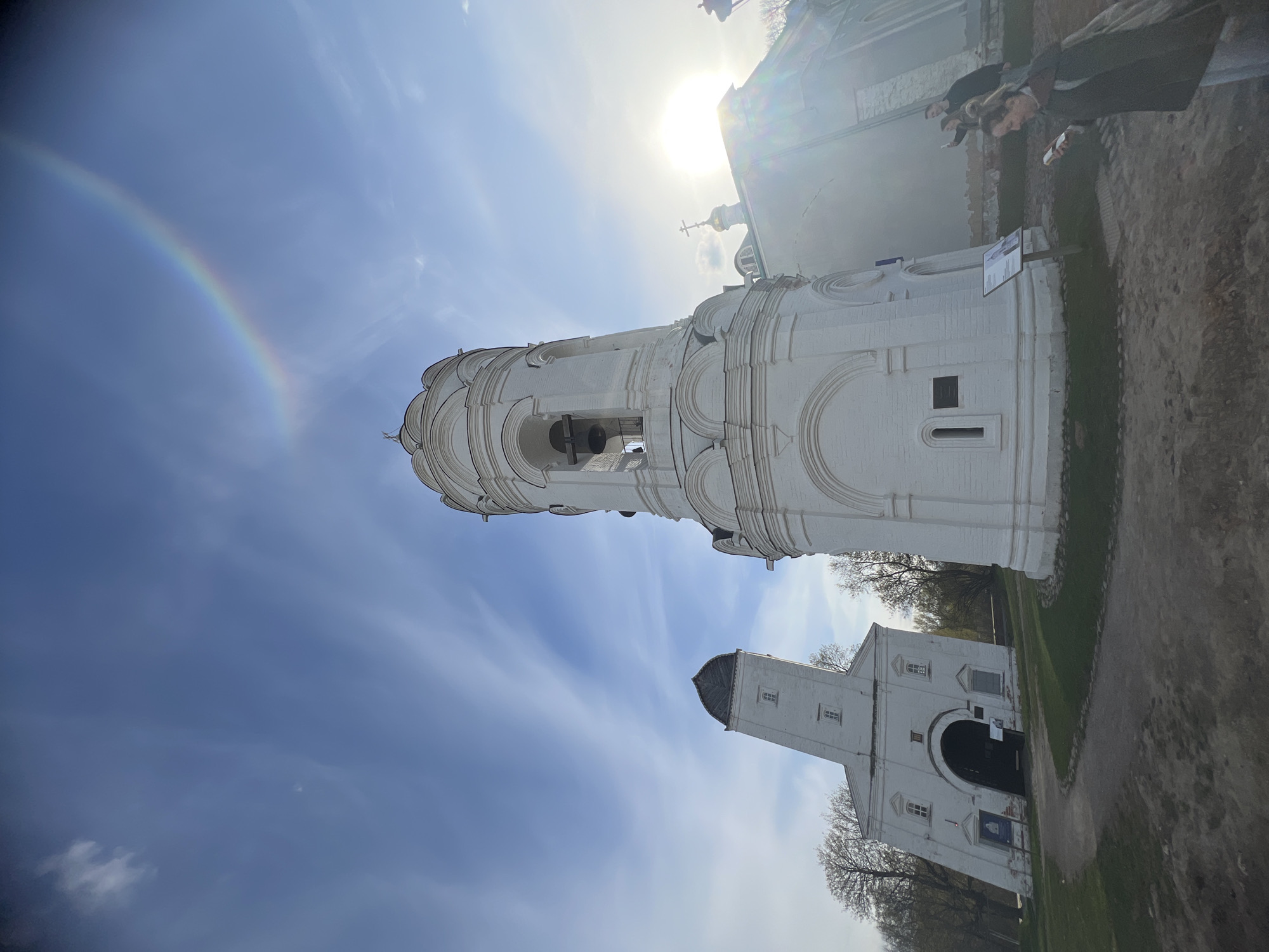 Rainbow arches over Moscow's historic Kolomenskoye Church during sunny afternoon