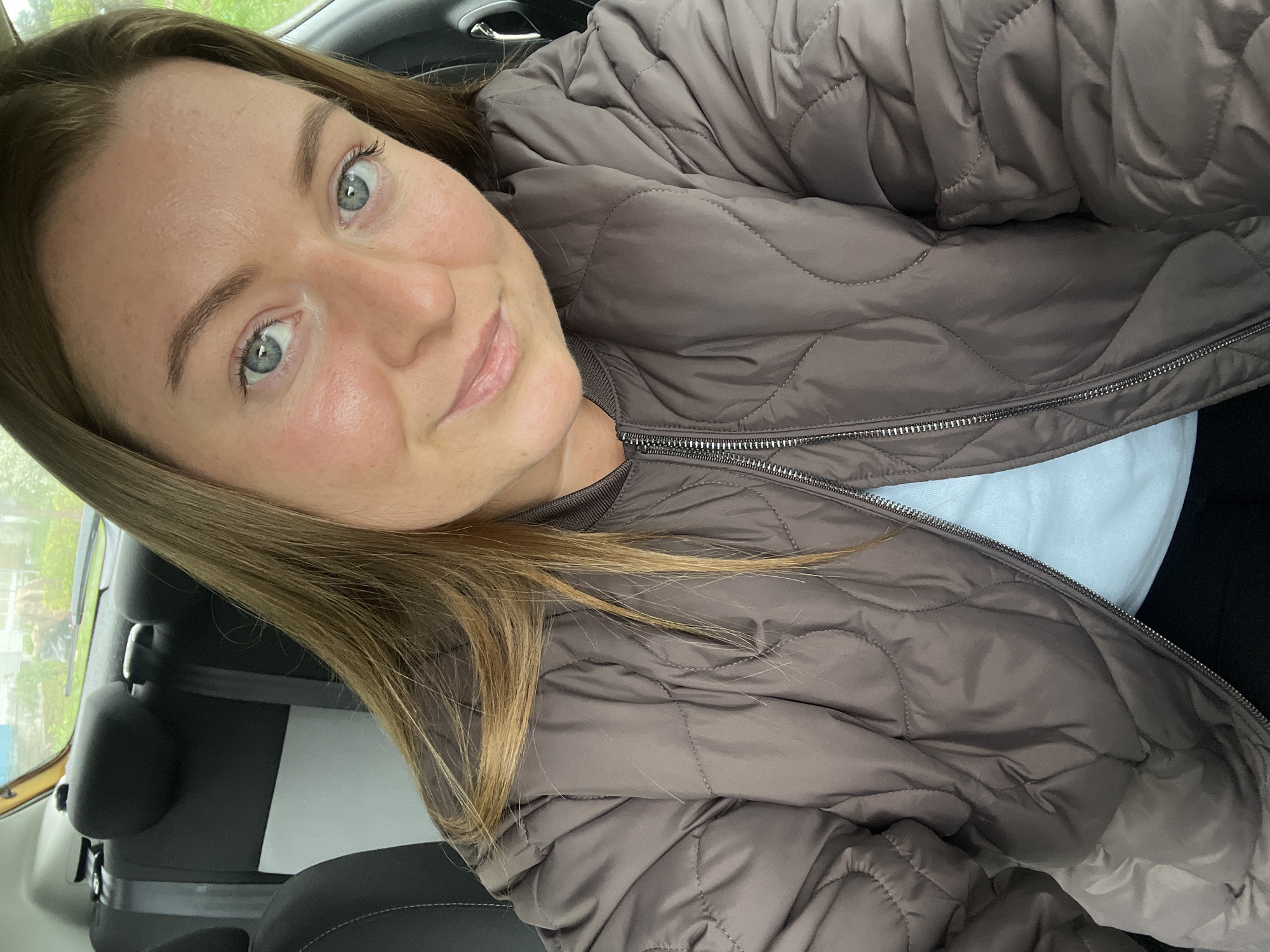 Woman takes selfie in car in Razdolye, Russia