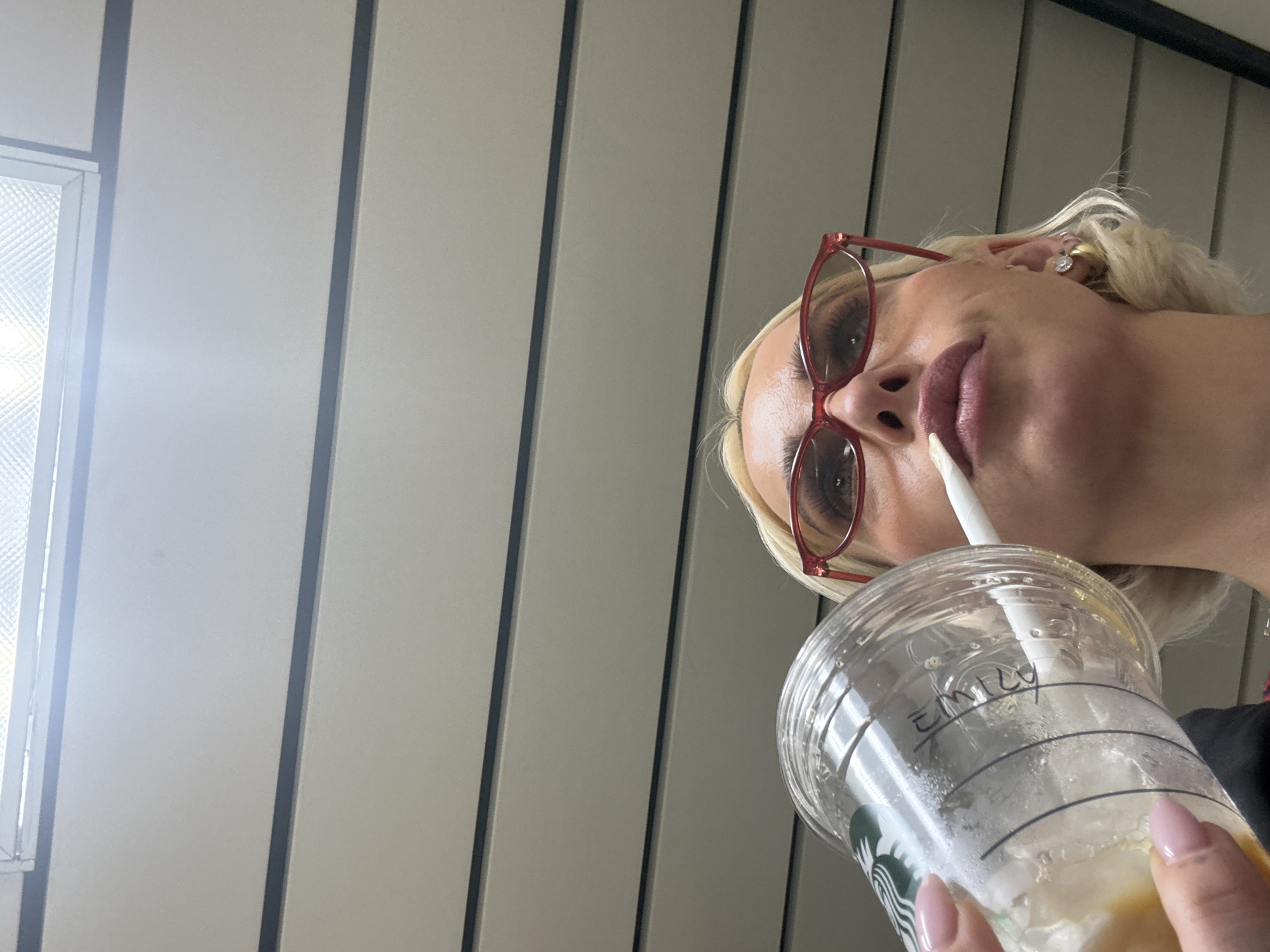 Woman enjoys Starbucks coffee in Ferno, Italy