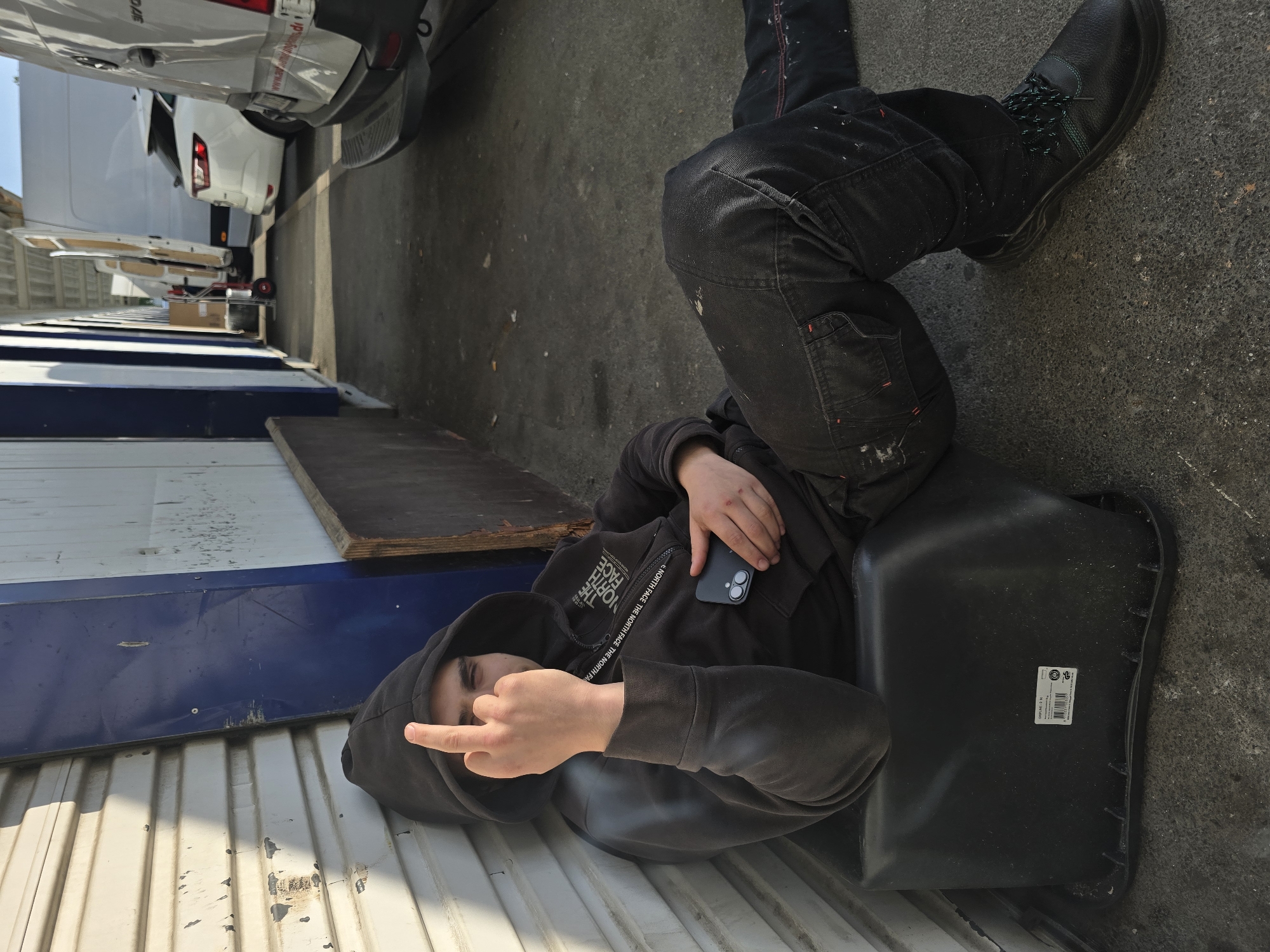 Person resting on container near vans in Kabelsketal