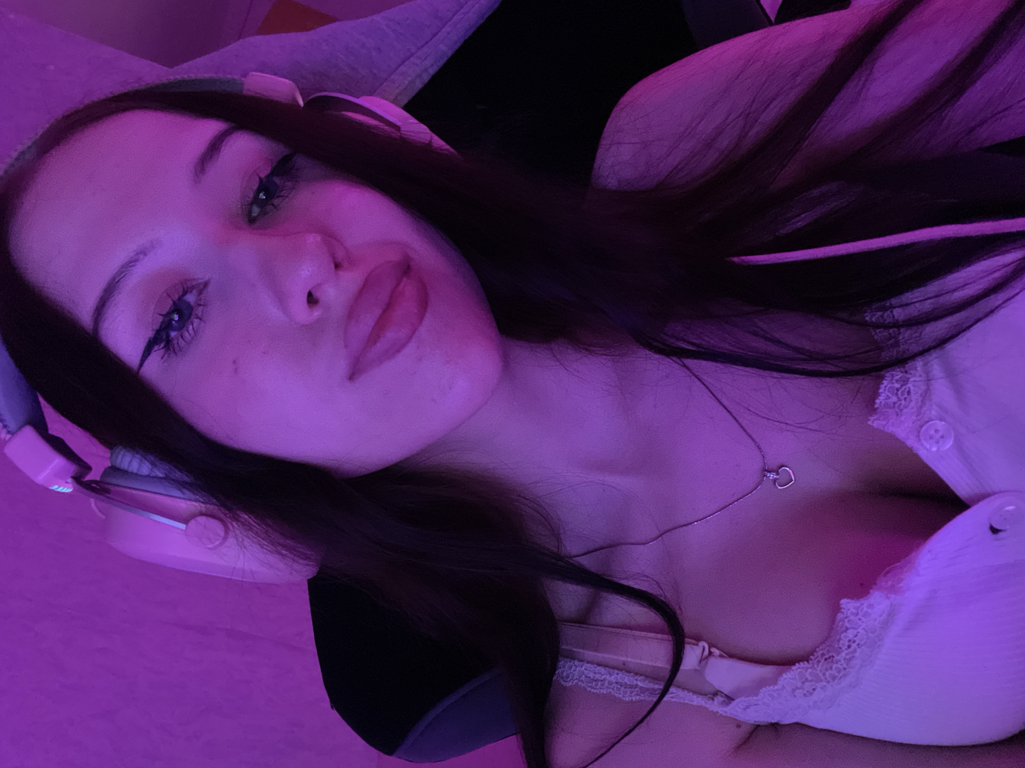 Woman photographed multiple times in purple-lit bedroom in Votkinsk
