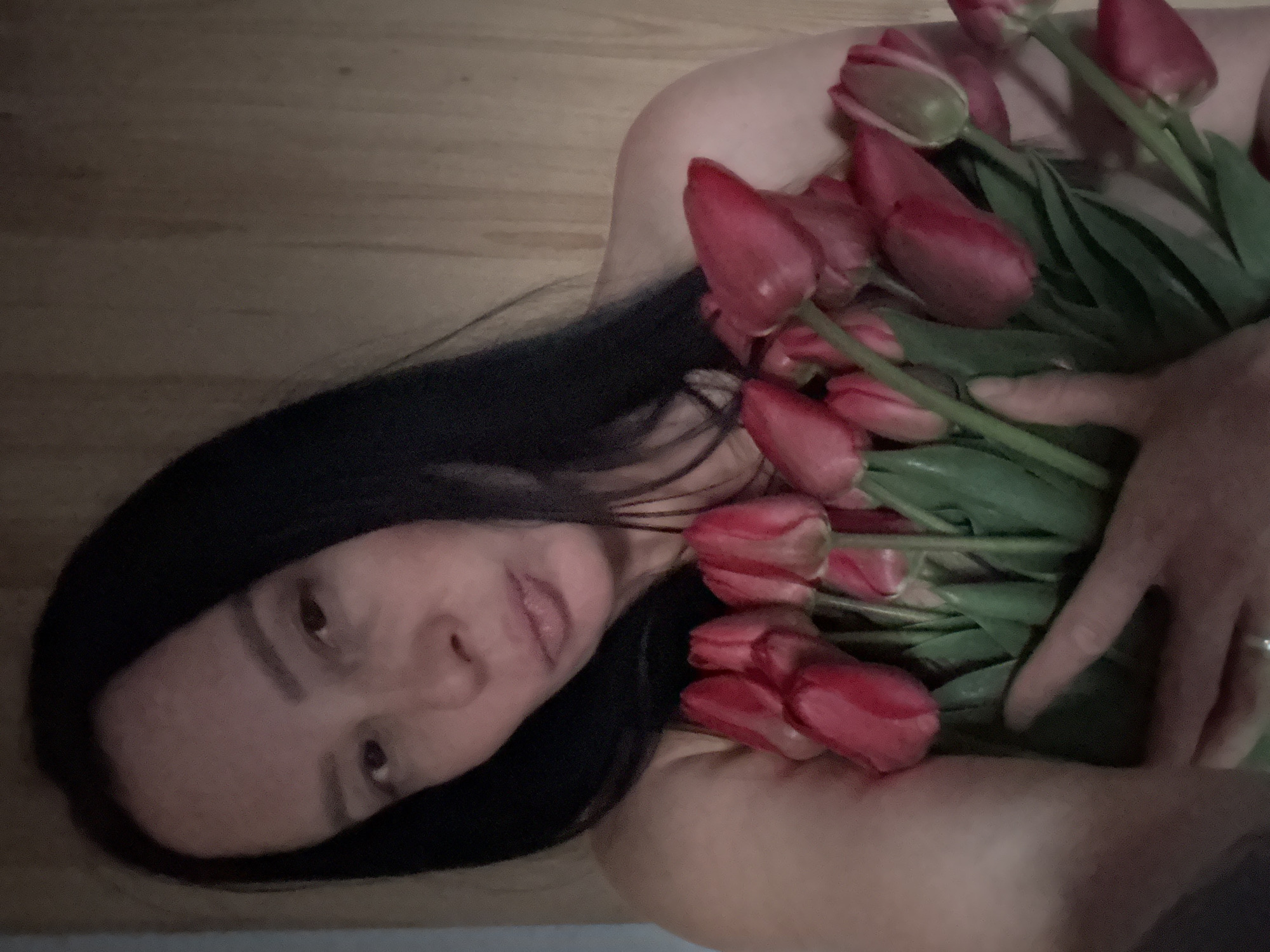 Woman poses with tulips across Chaikovsky locations during spring afternoon