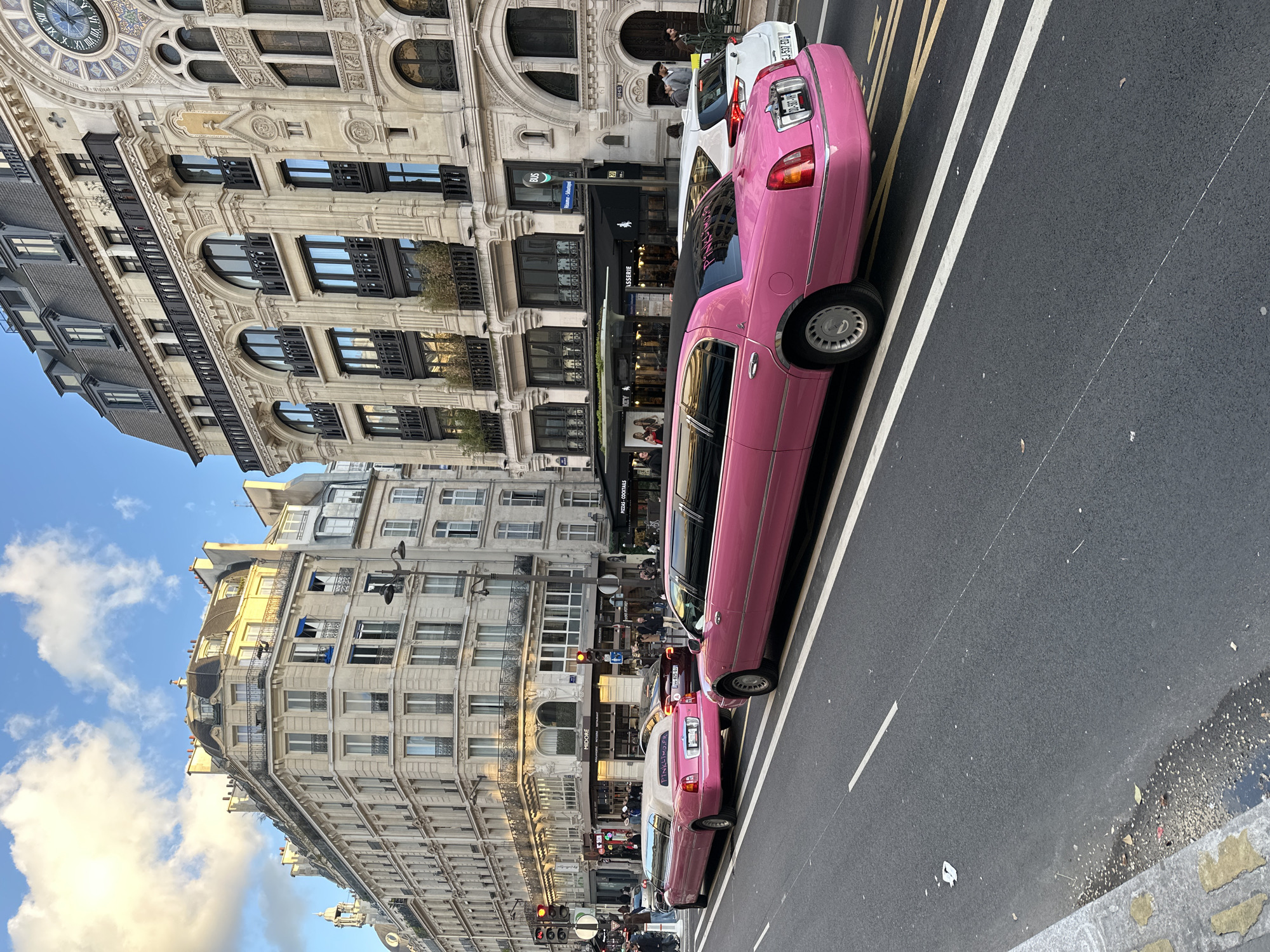Parisians document everyday moments amid pink limousine street scenes
