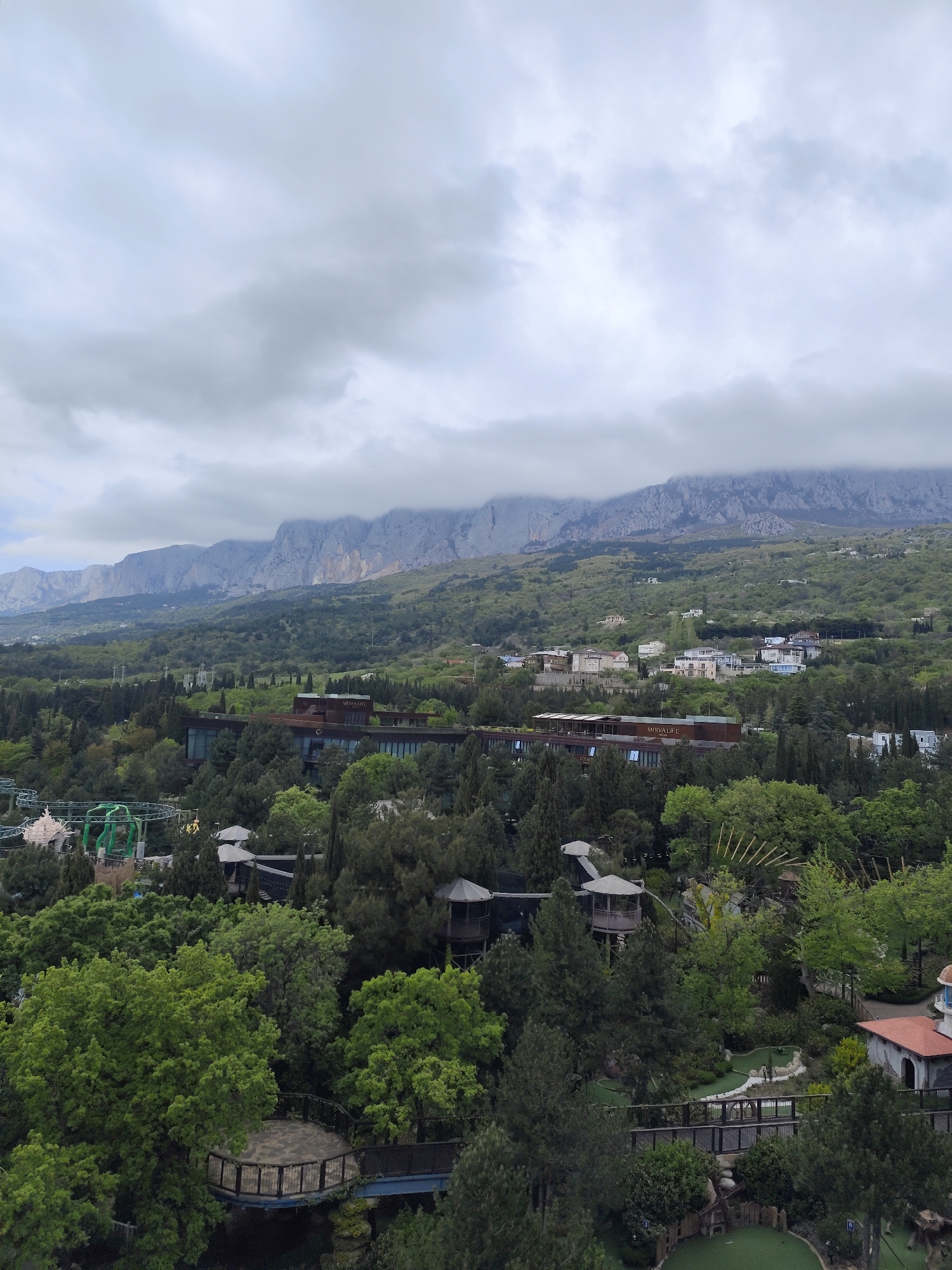 Coastal landscape with mountains and modern buildings observed in Ukraine