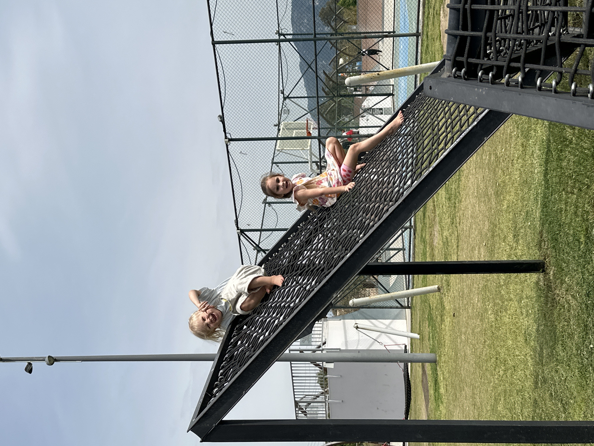 Children play on climbing nets, baby crawls in Fethiye