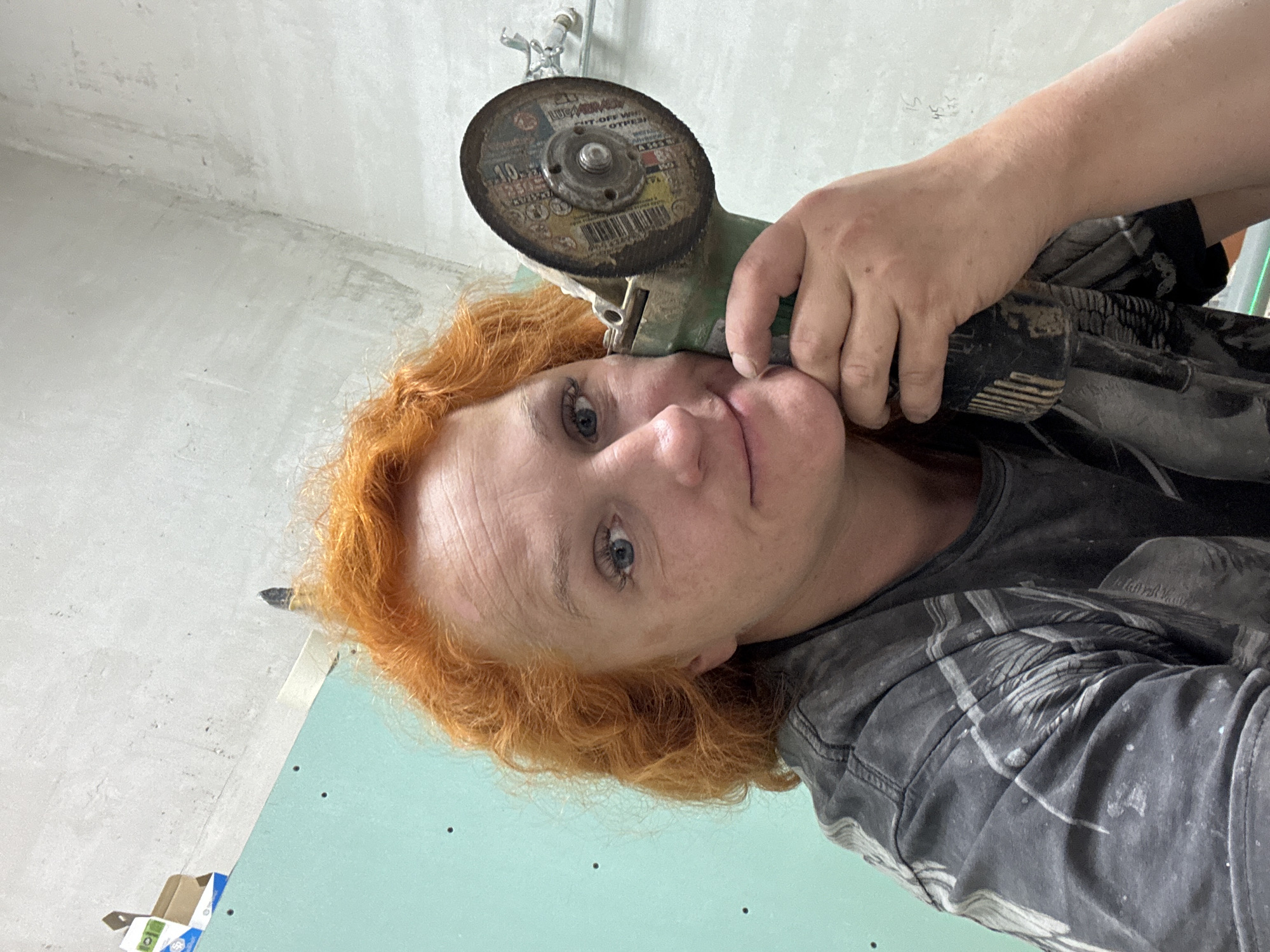 Woman performs renovation work with power tools in Chaikovsky