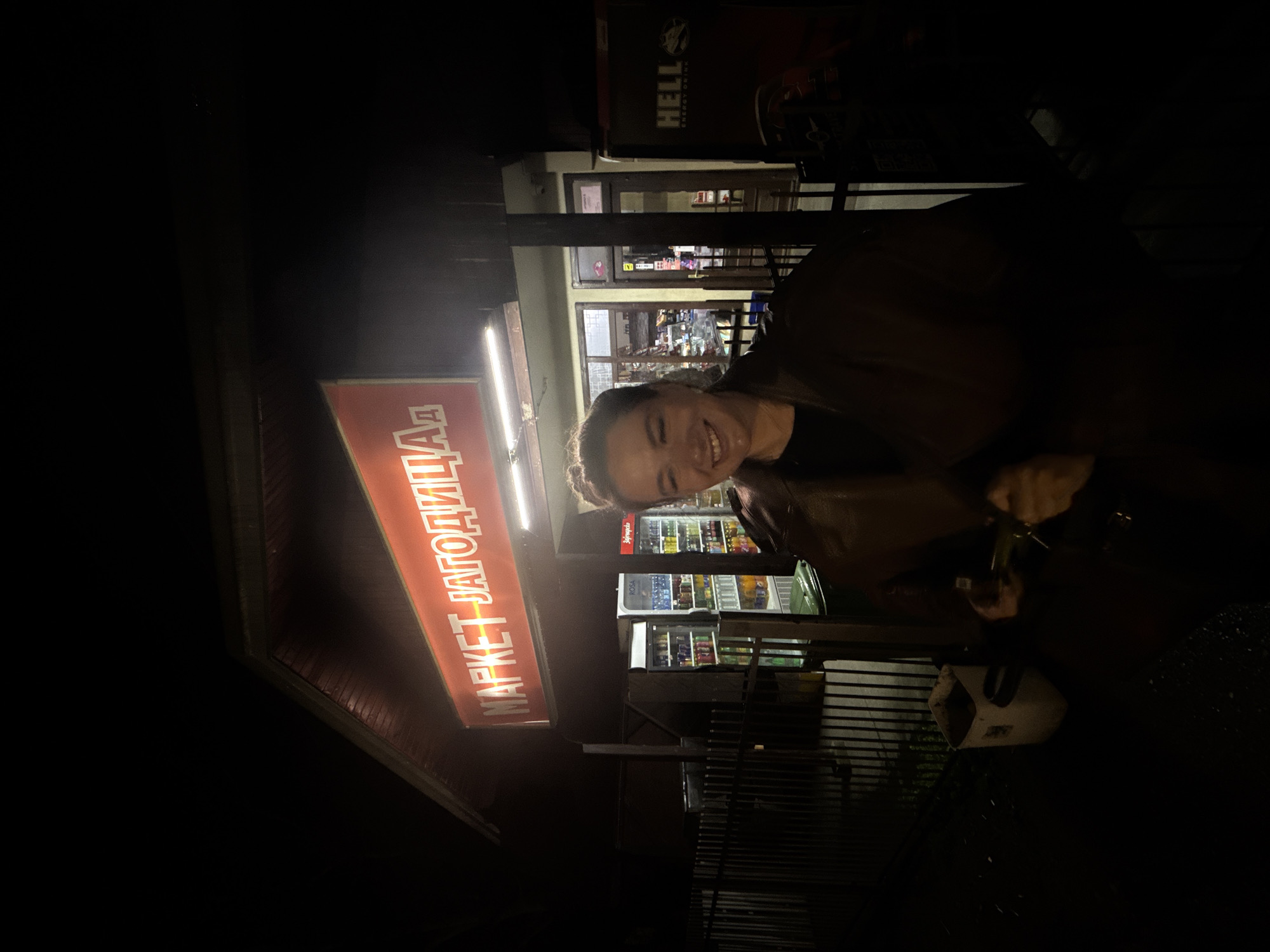Woman poses outside convenience store in Serbian town