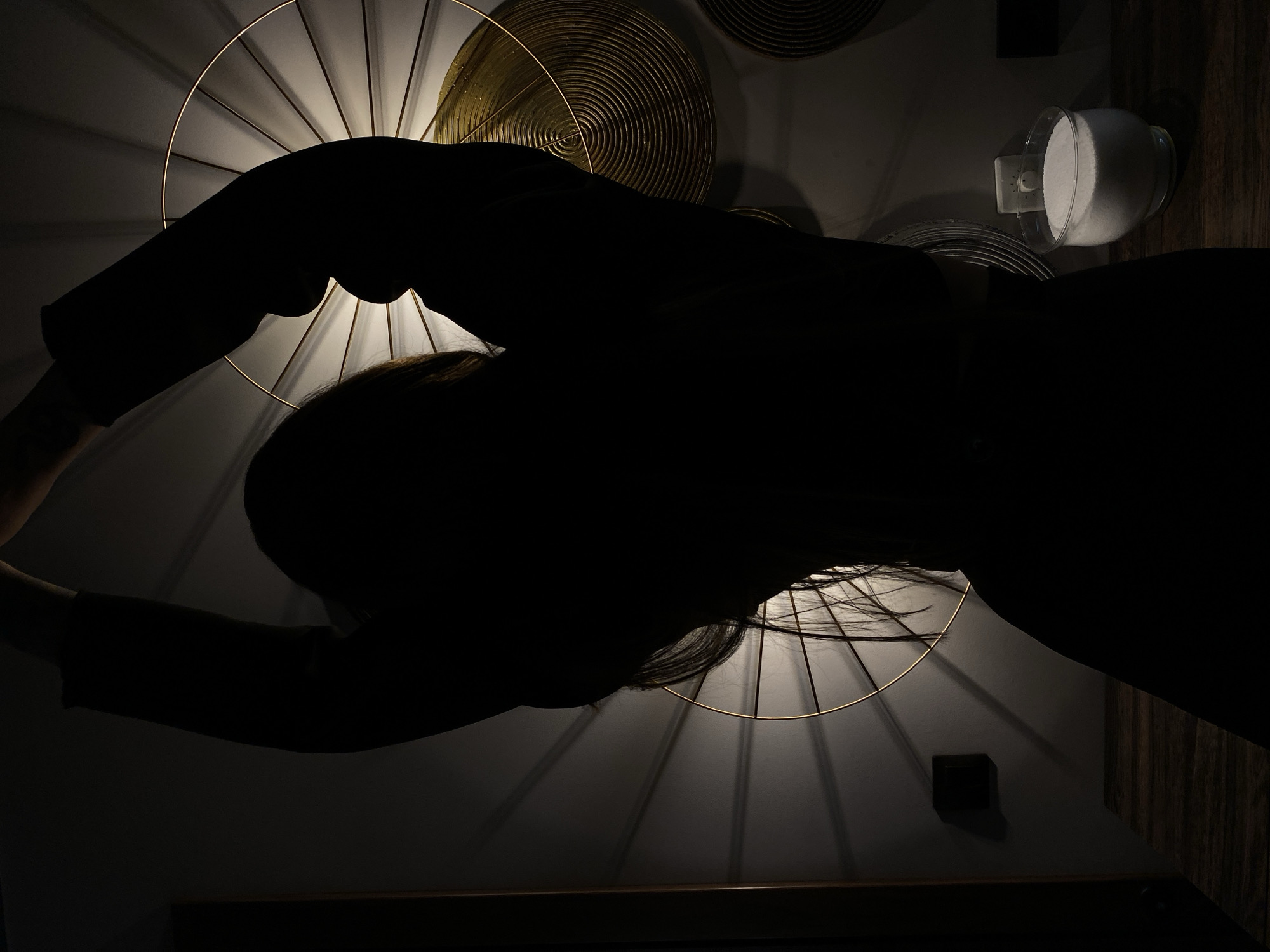 Woman poses with decorative lighting installation in Votkinsk interior