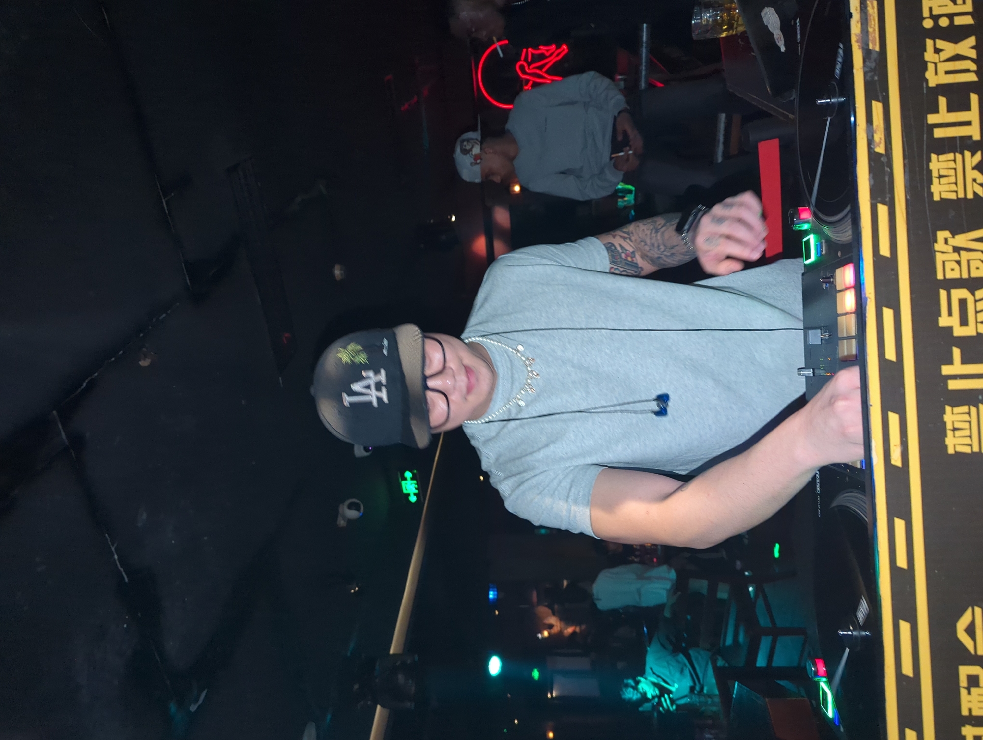 Nightclub scene documented in Liangjiang with dancing patrons, DJ