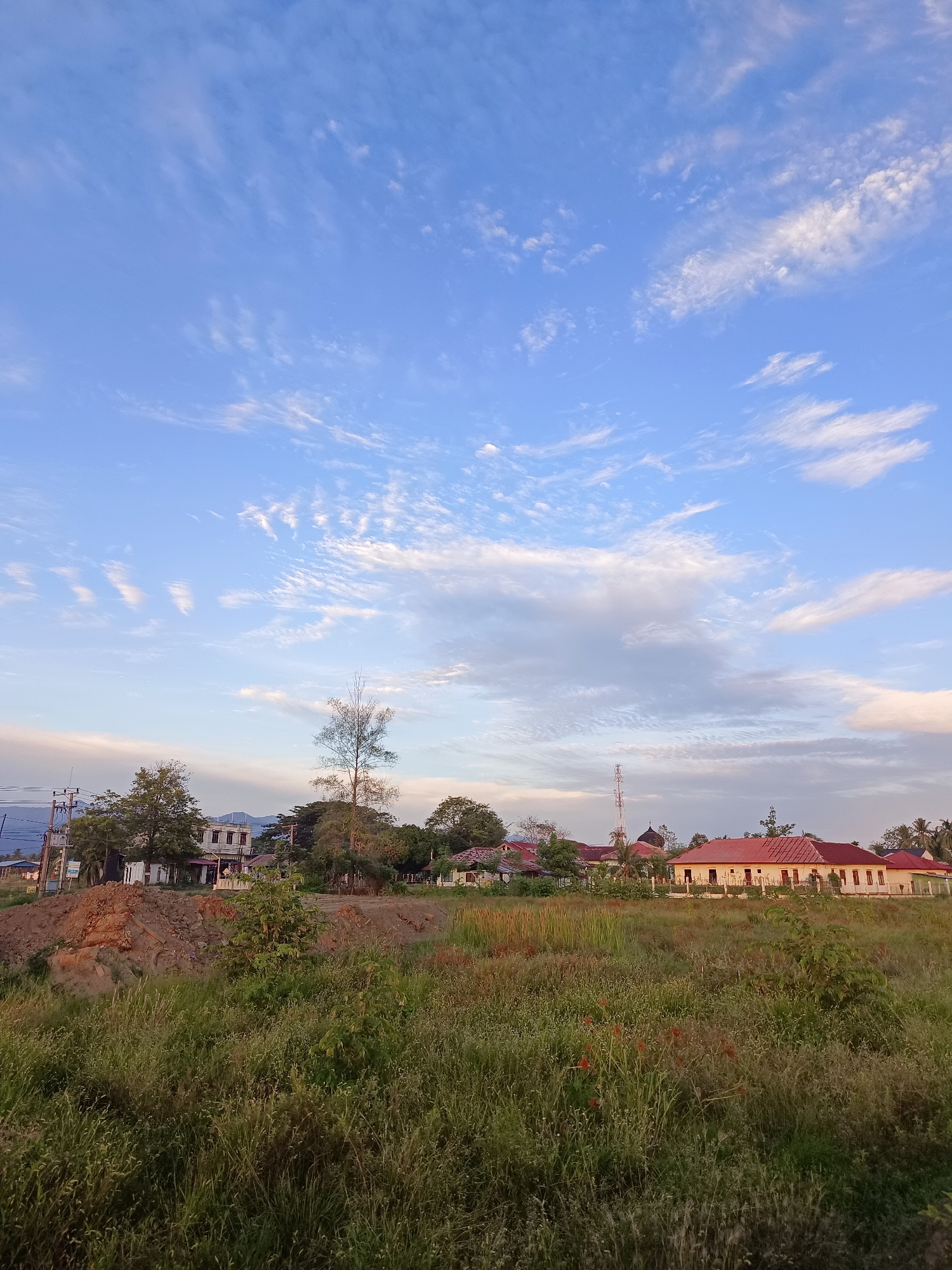 Sunset over the fields and roads of Meunasah Raya