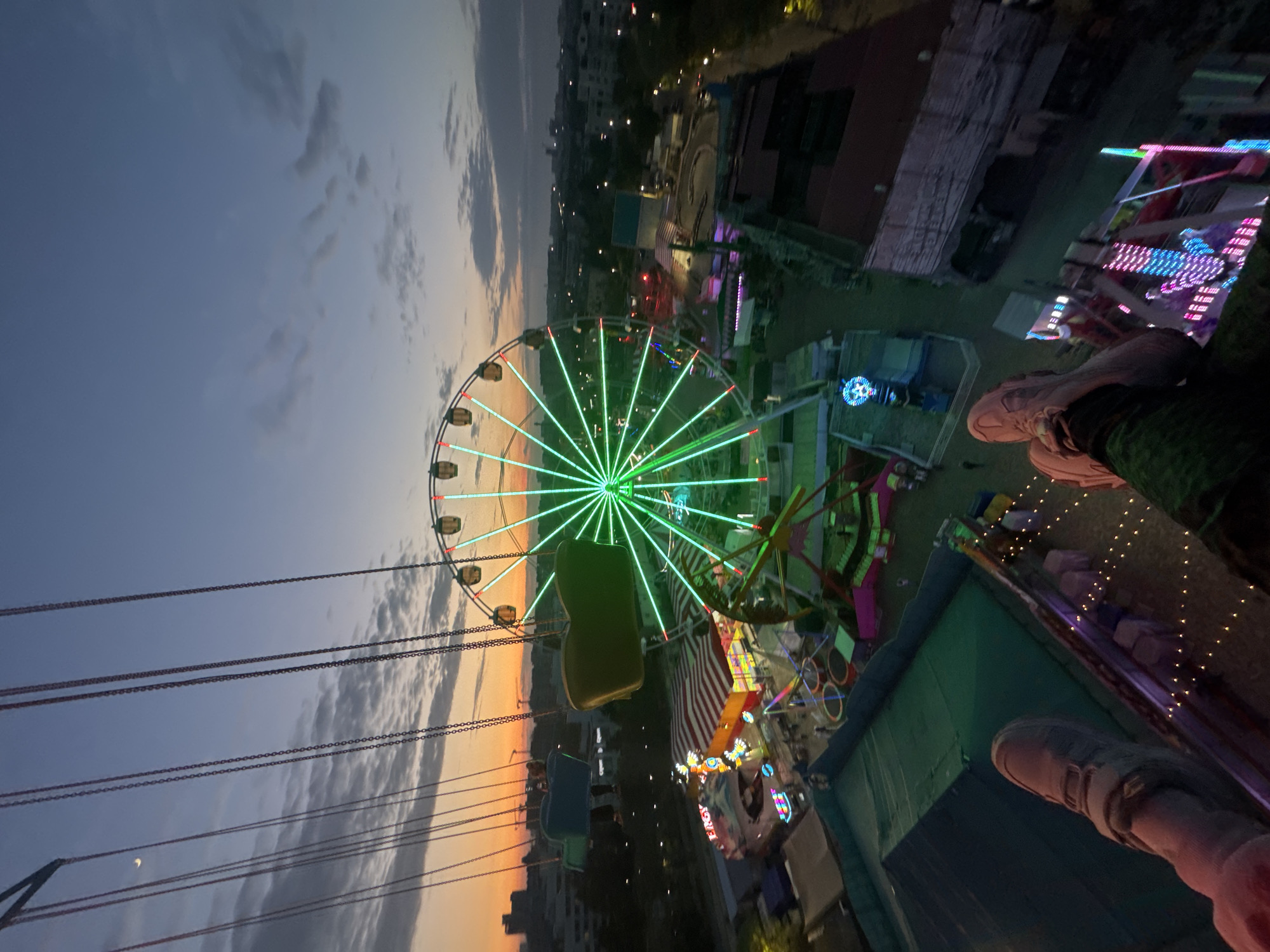 Evening carnival lights illuminate Yevpatoriya amusement park attractions