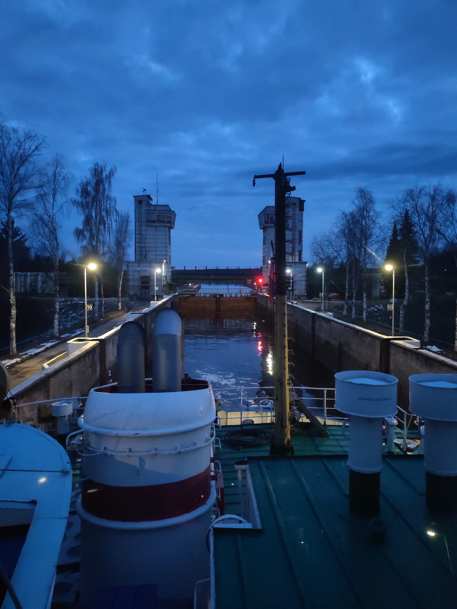 Ship transits canal lock system during evening hours