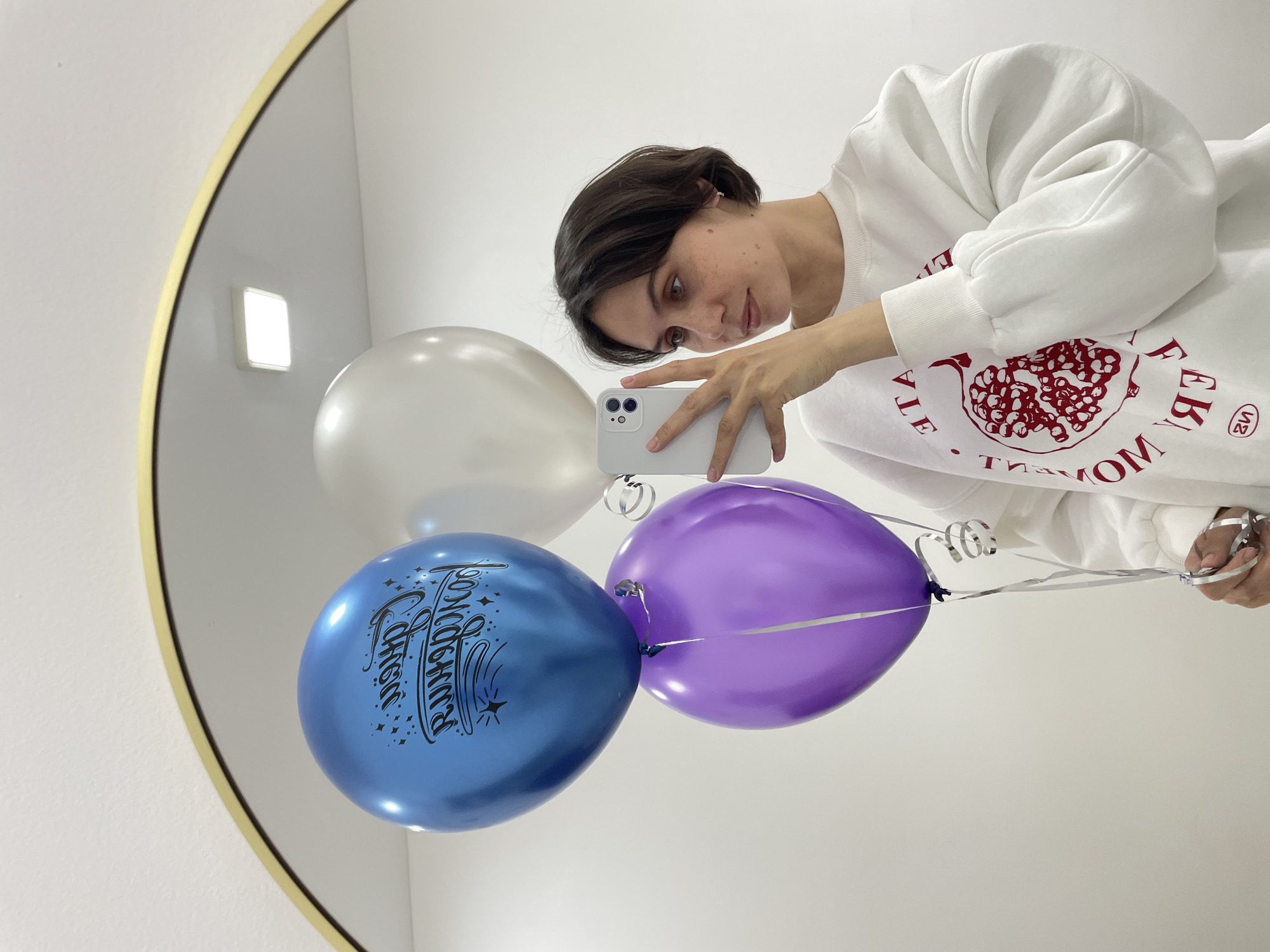 Young person takes mirror selfie with balloons in Izhevsk