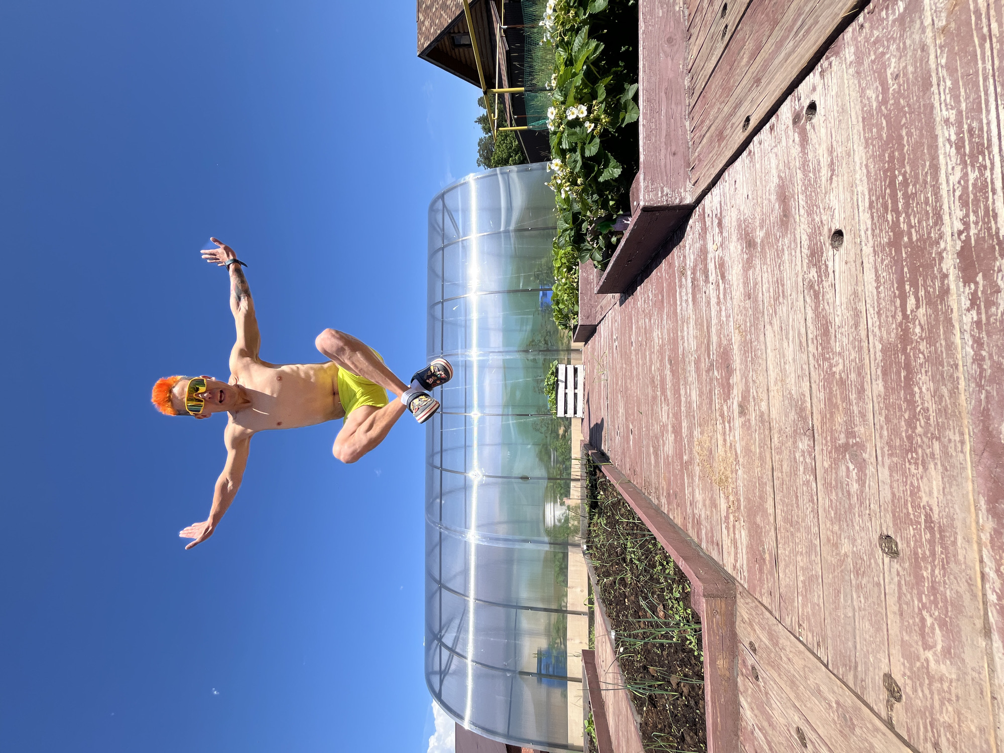 Orange-haired man photographed jumping, child plays in Chaikovsky garden