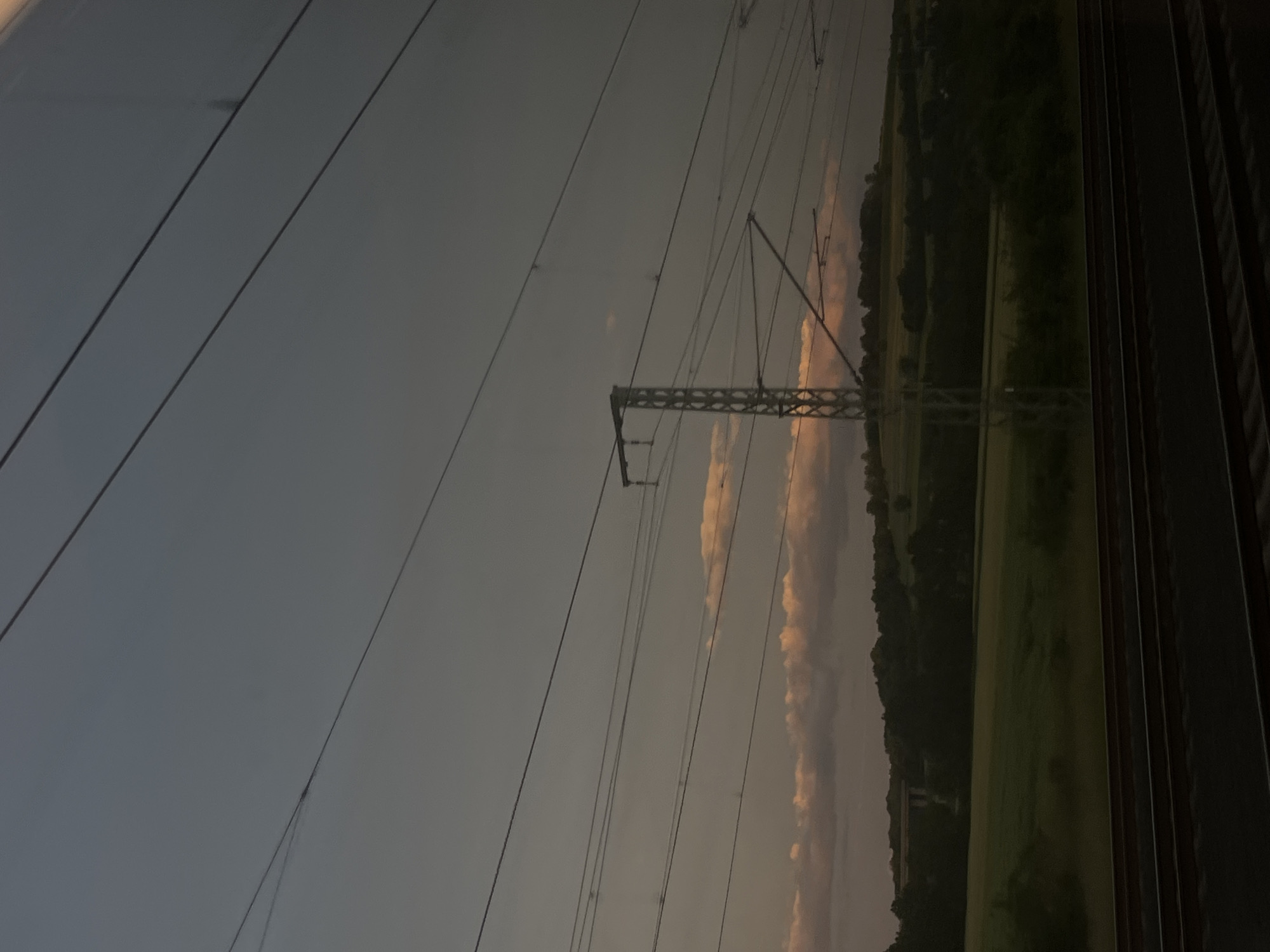 Train passenger documents 16-minute dusk journey through rural landscape
