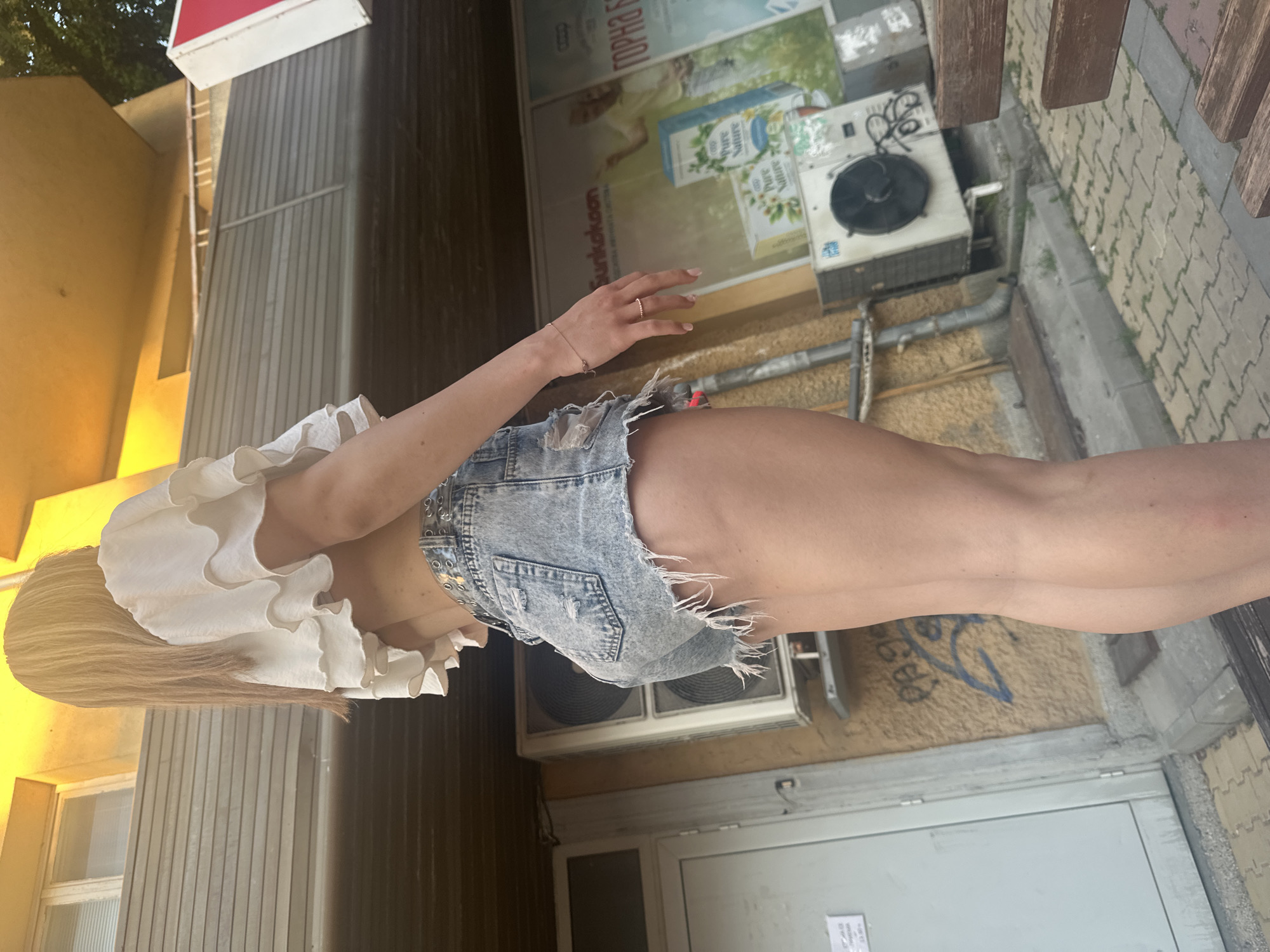 Friends chilling outside a Shumen shop on a summer afternoon