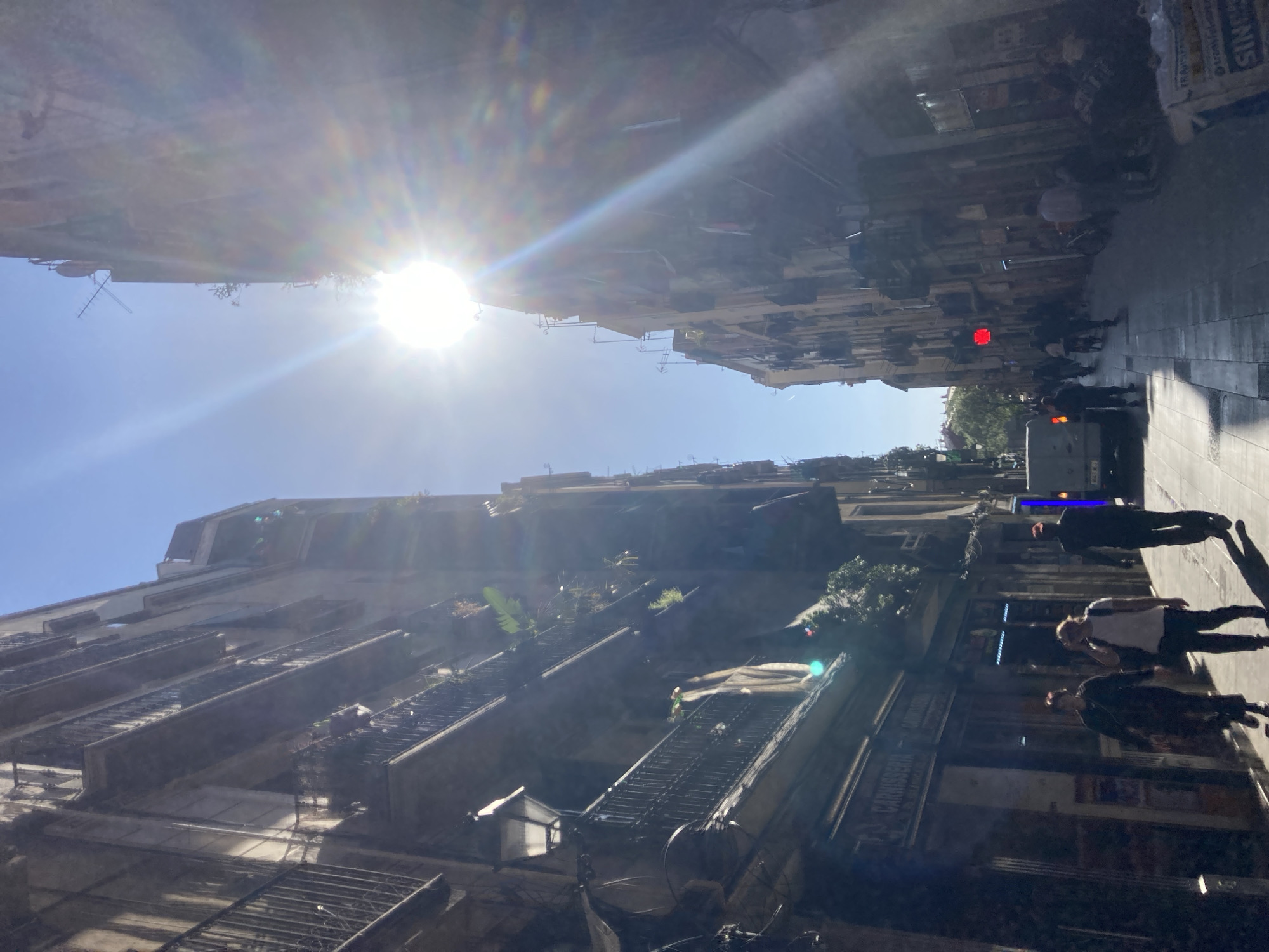Urban street scene documented with sunlight creating lens flare