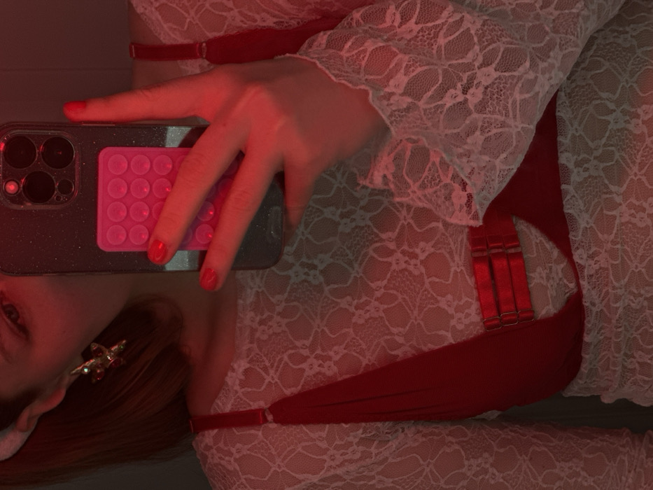Woman conducts red-lit photoshoot with novelty documents in Grebeni