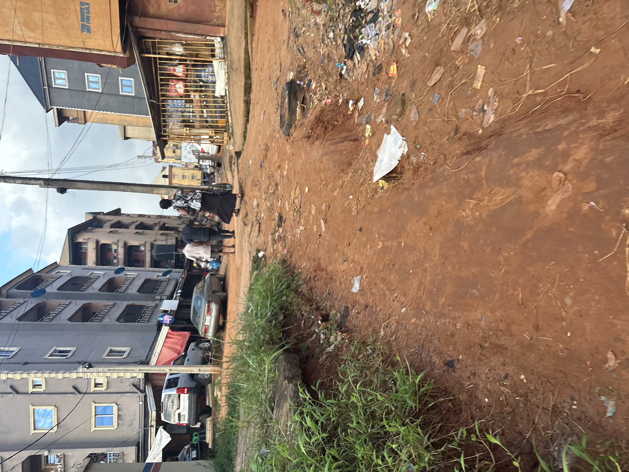 Dirt roads and debris line Onitsha and Nkpor streets
