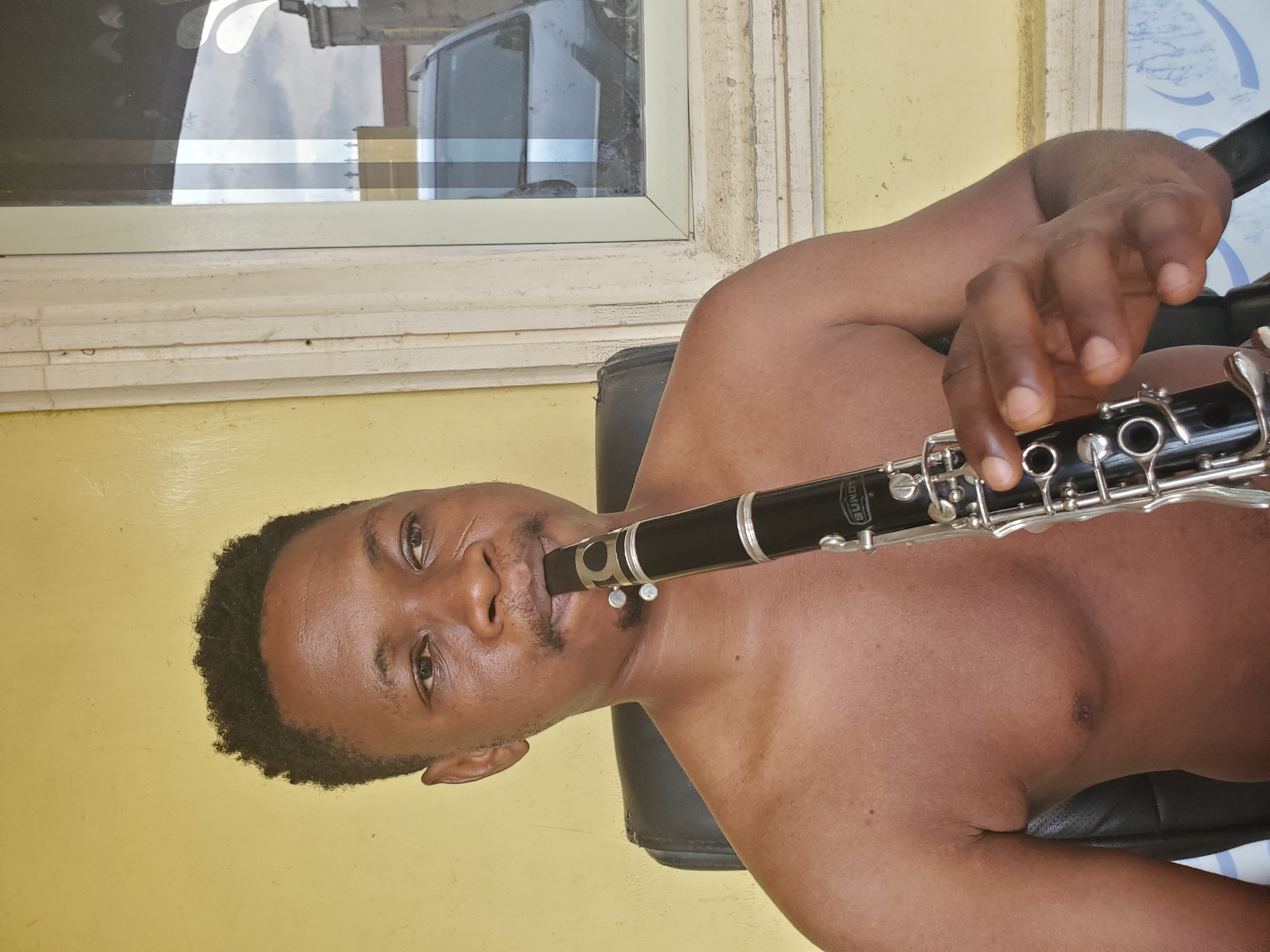 Man plays clarinet in Mararaba, Nigeria