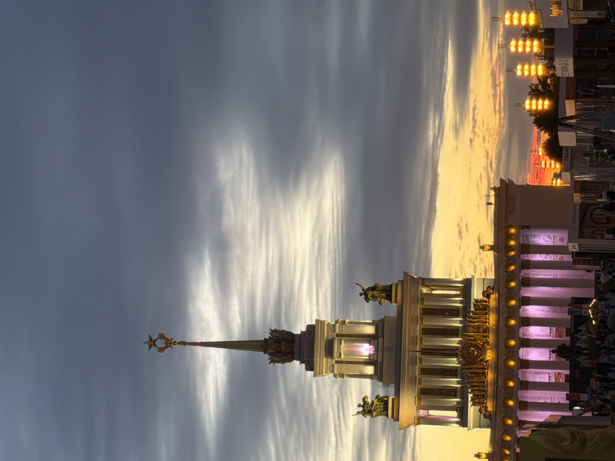 Festival gathering in public plaza with performances and illuminated displays