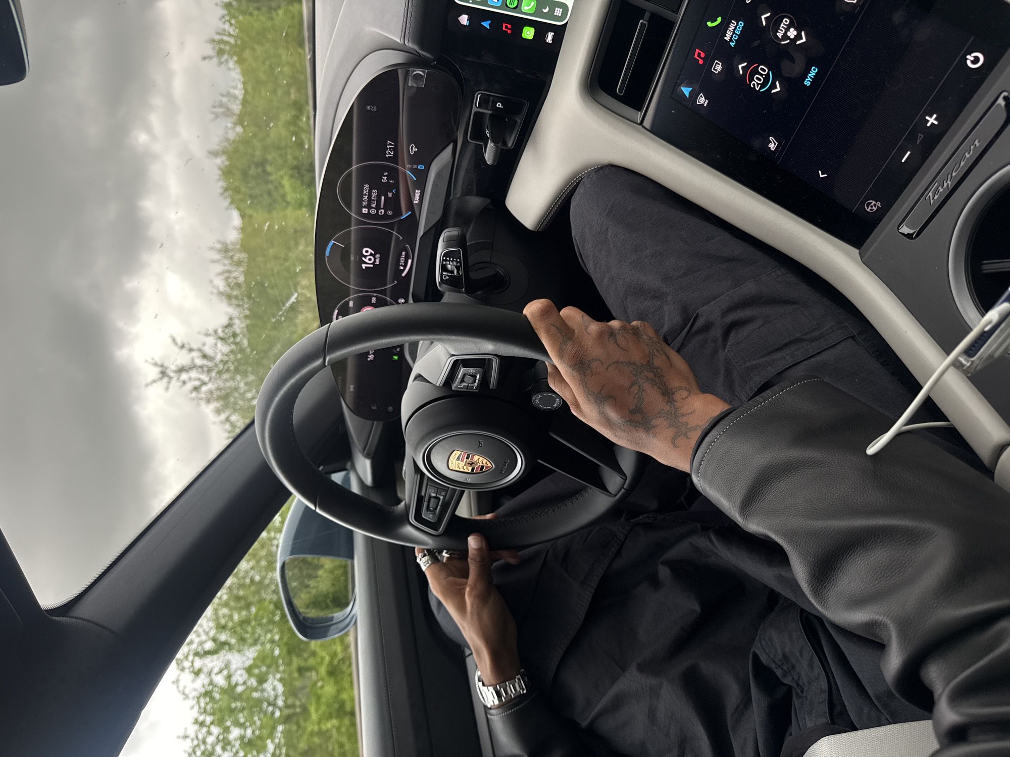 Couple photographed inside Porsche Taycan in French countryside