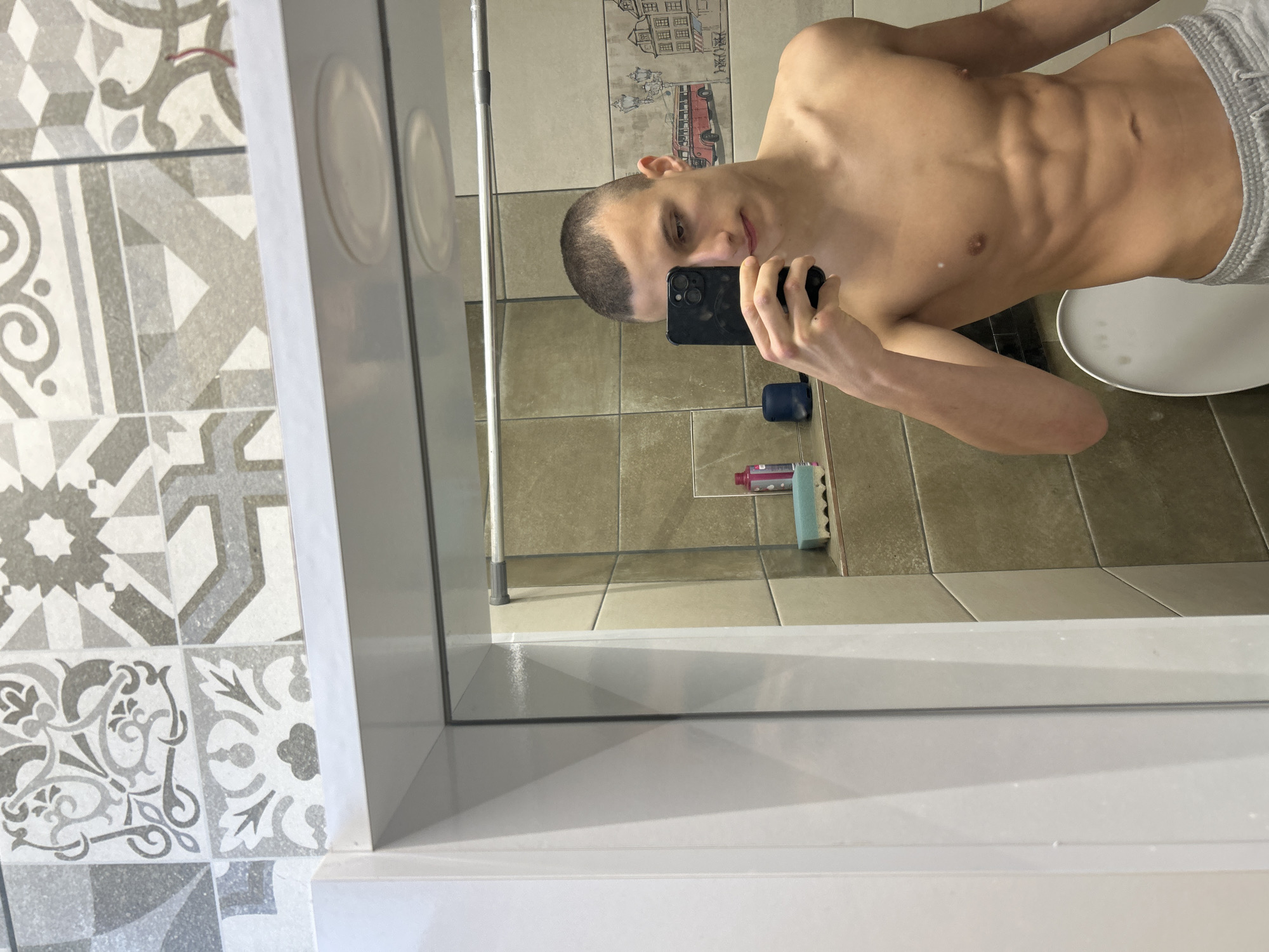 Young man takes bathroom mirror selfies in Burgas, Bulgaria