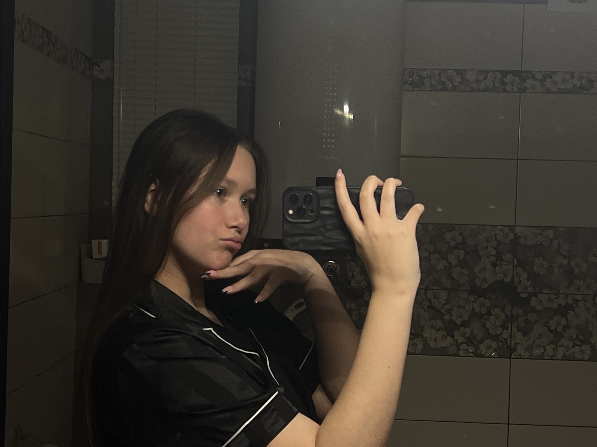 Woman takes mirror selfie in pajamas in Chaikovsky, Russia