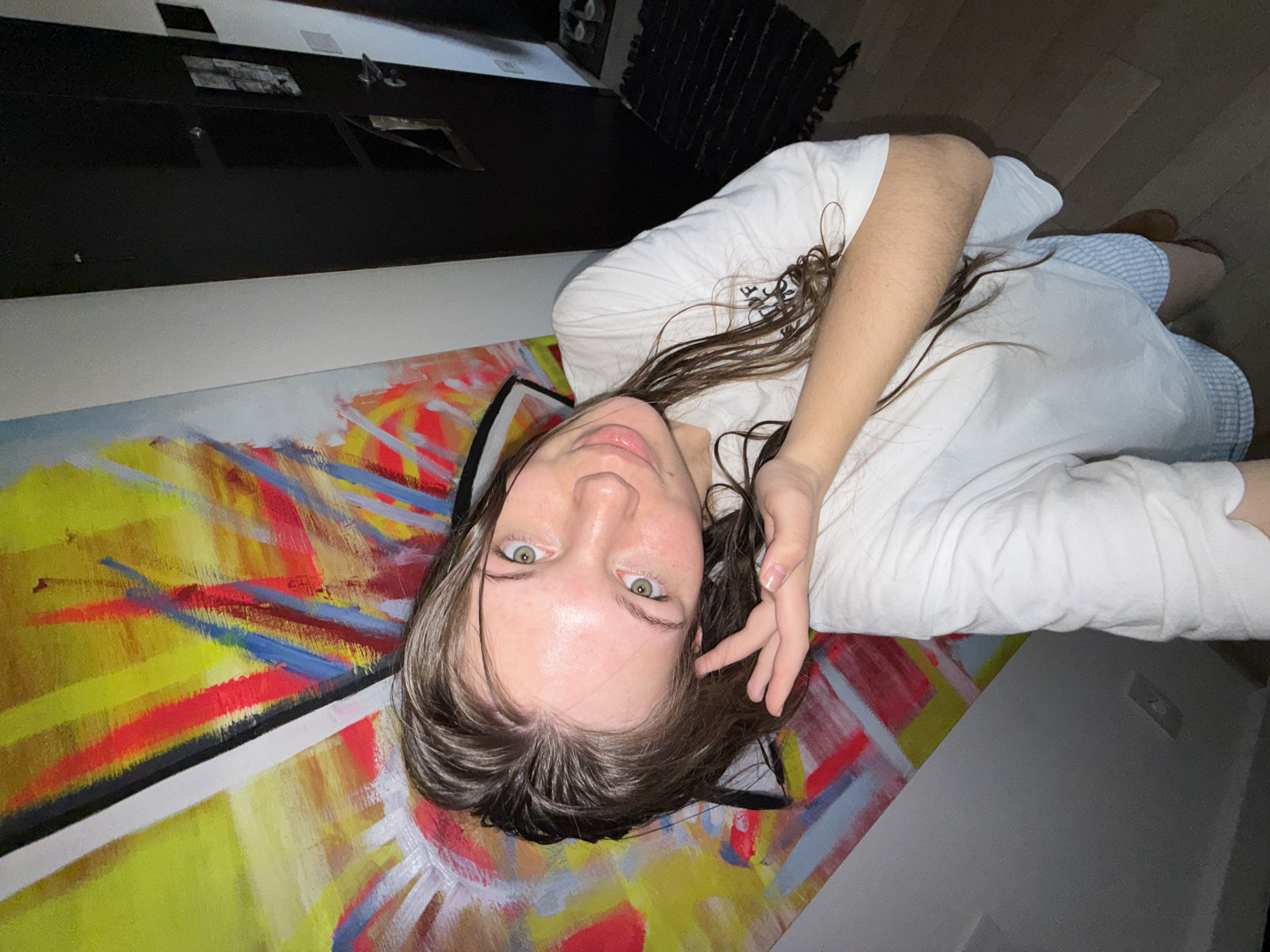 Woman photographed on painted floor, taking mirror selfie in Serbia