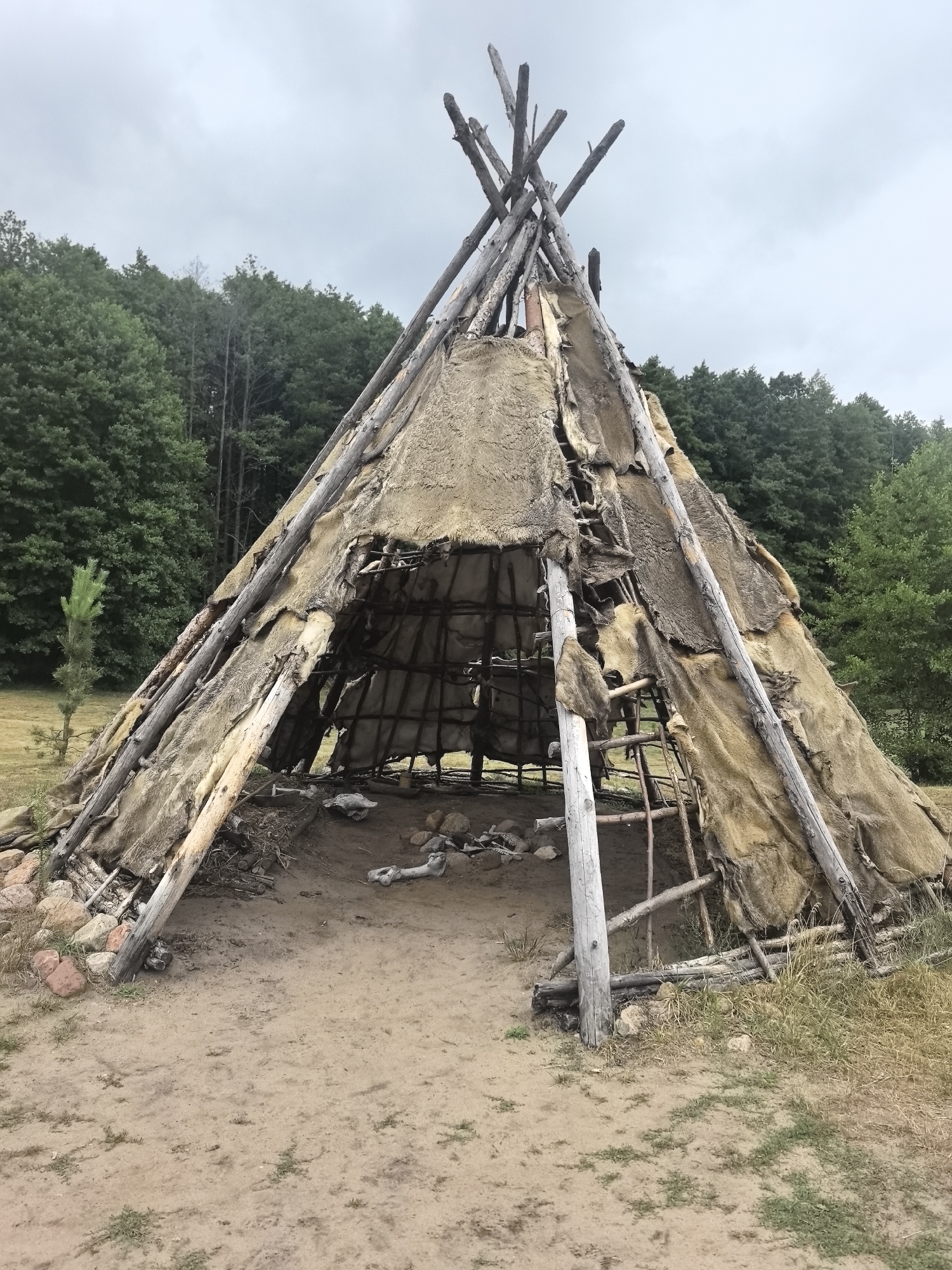 Reconstructed primitive settlement with traditional structures and artifacts