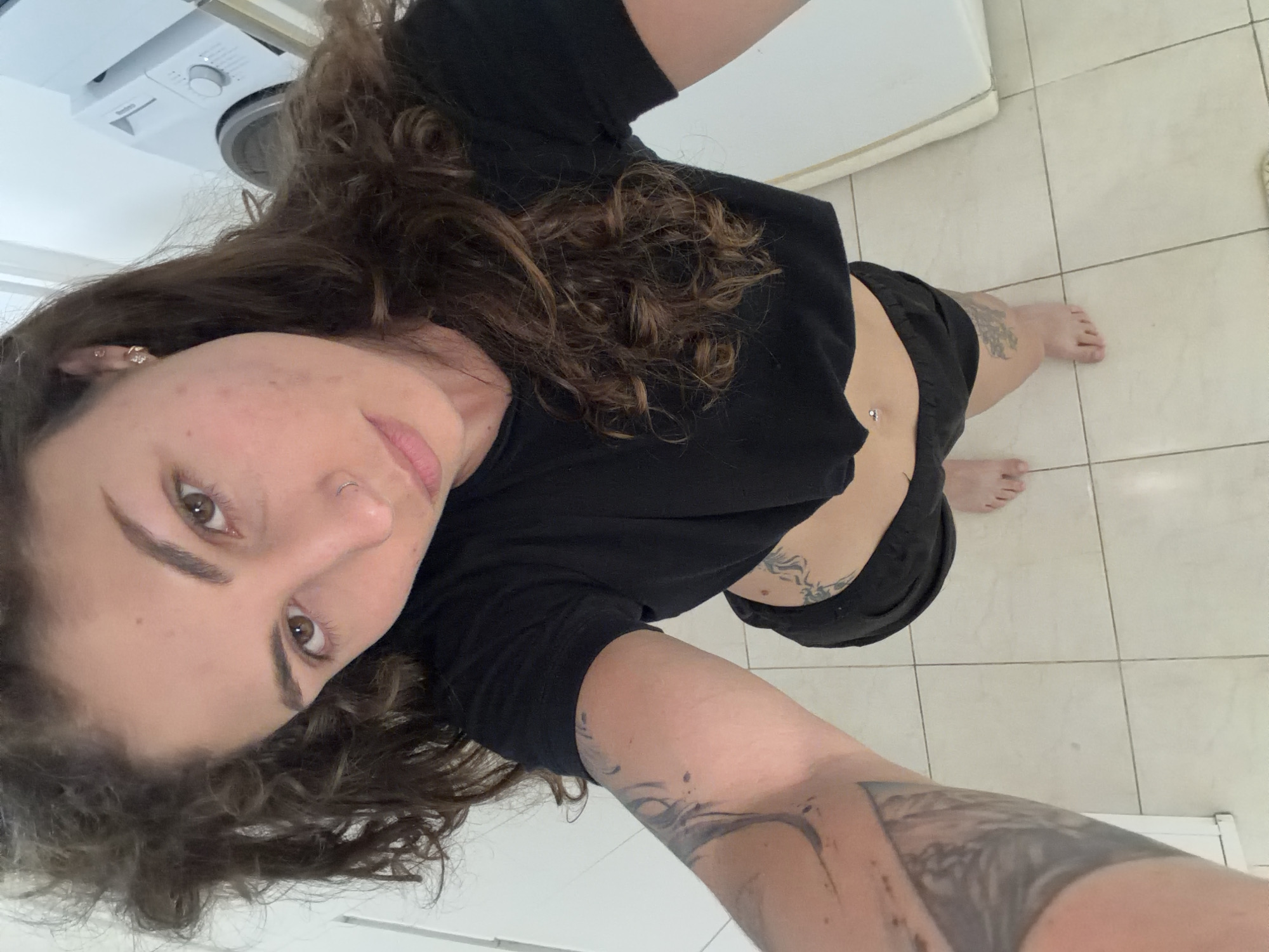 Woman takes selfie in tiled room in Kiryat Bialik