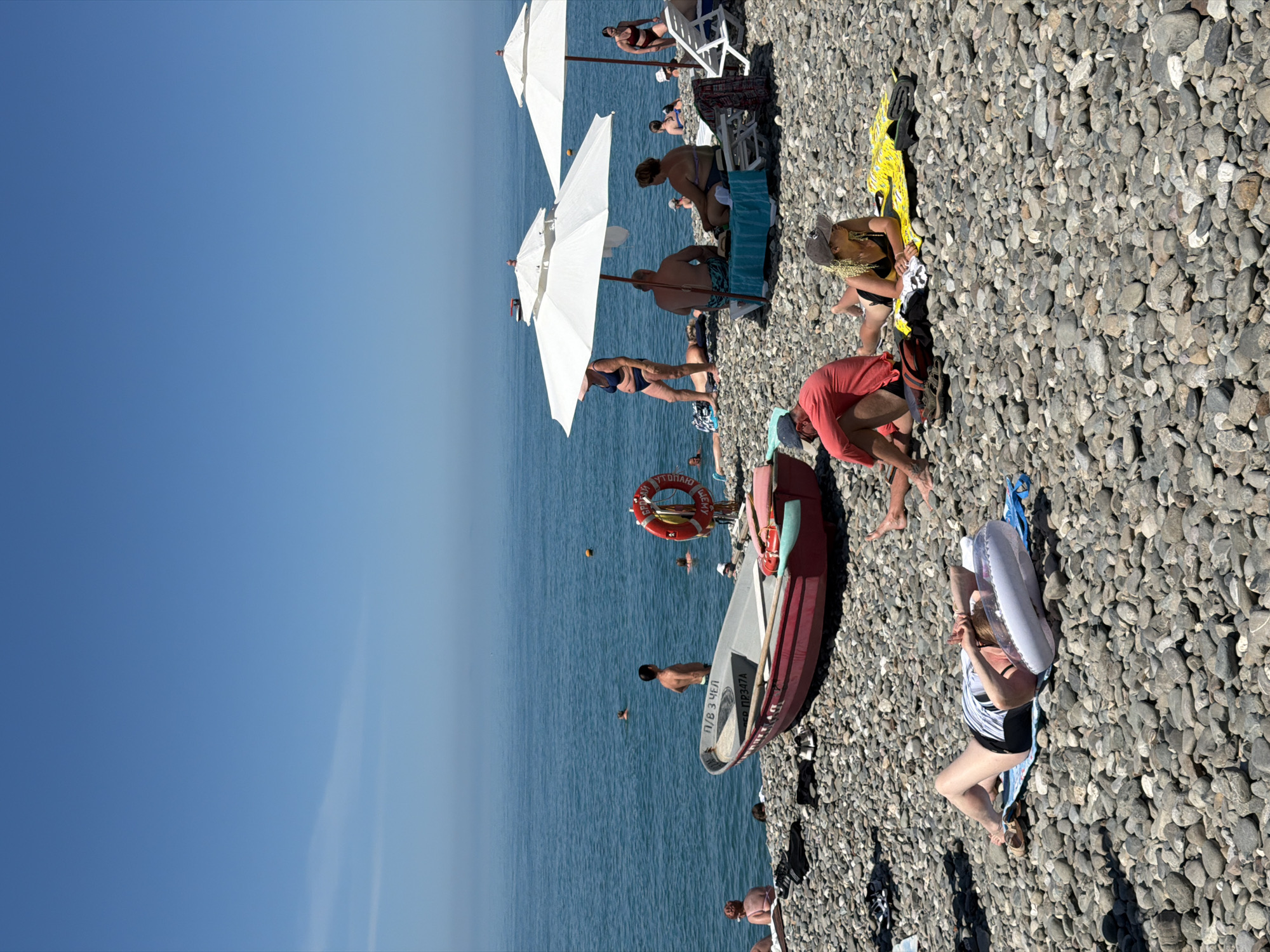 Crowded Black Sea beach in Sochi on a clear summer morning