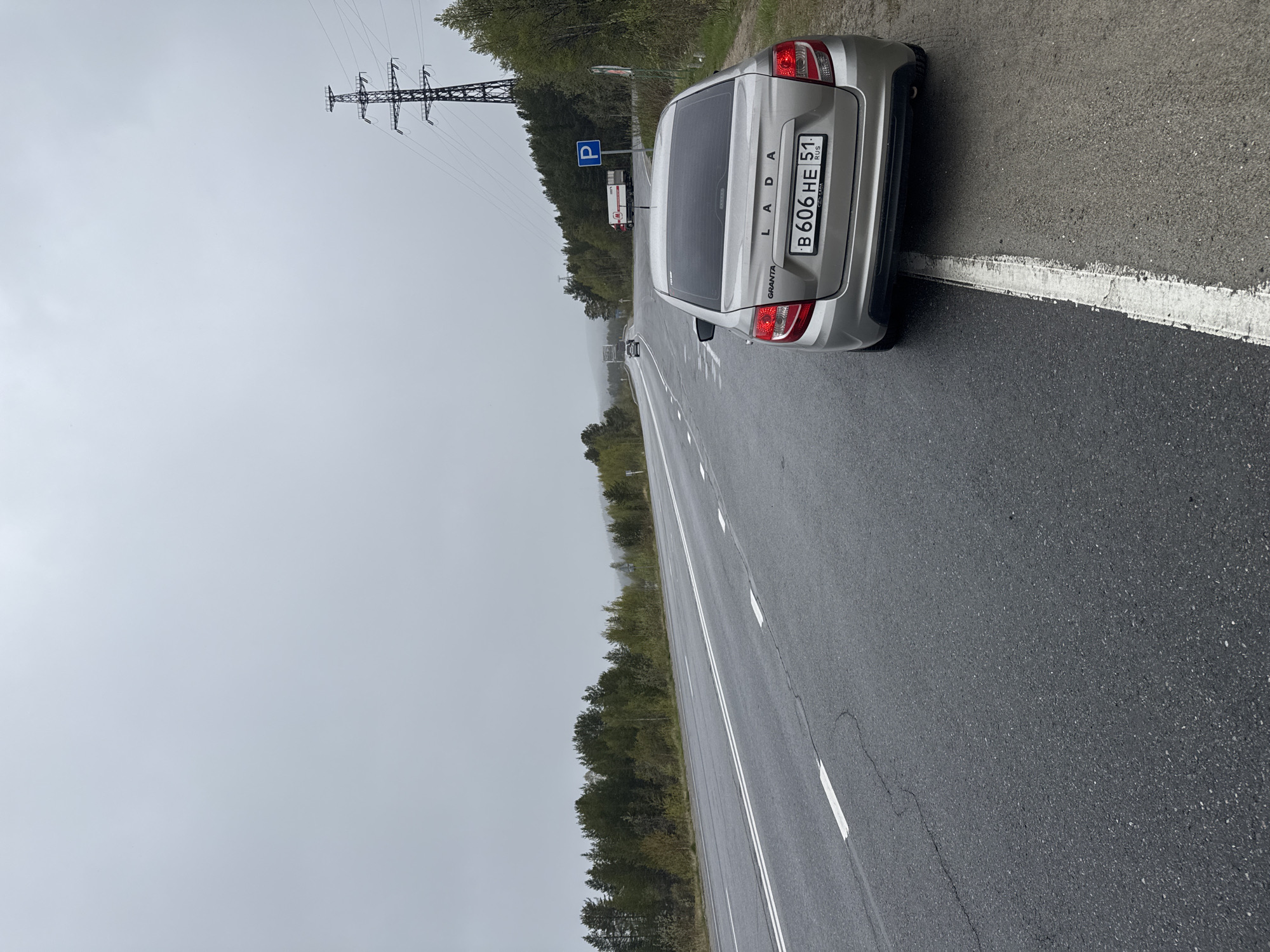 Silver Lada parked on wet road near Tik-Guba, Russia